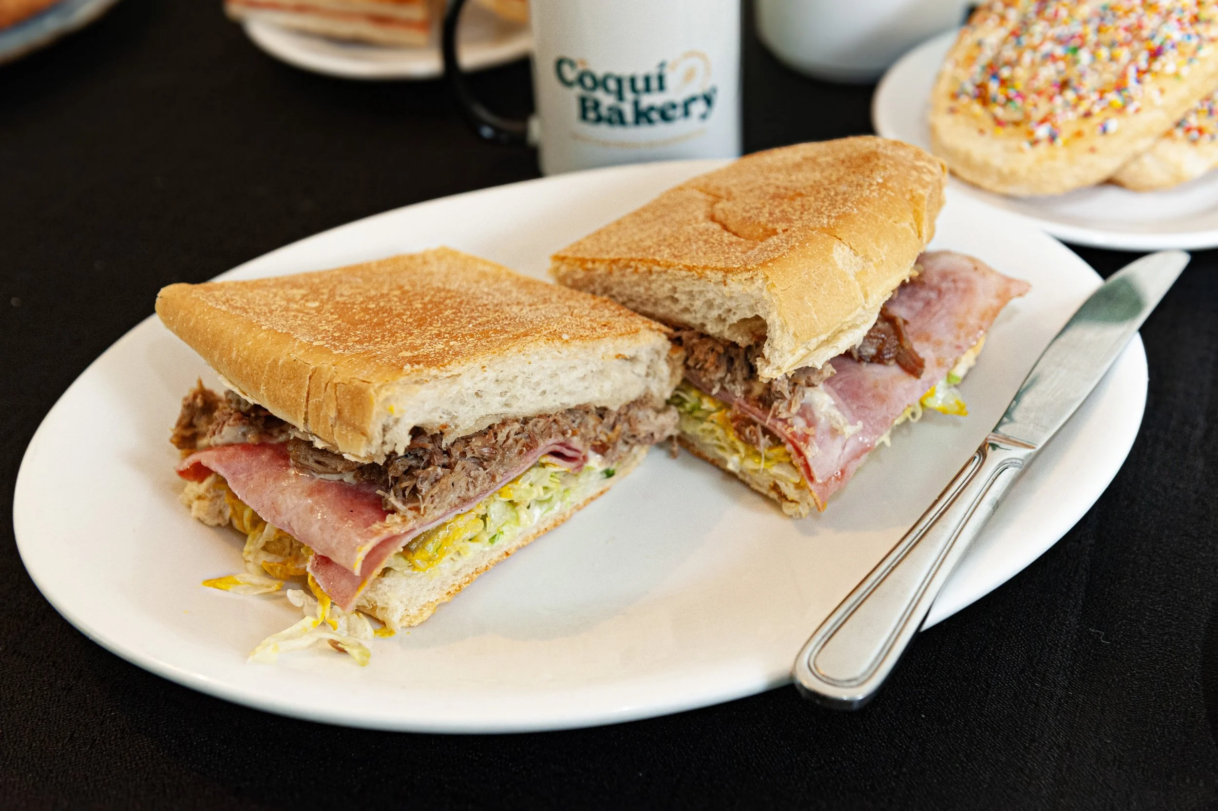 Cuban Sandwich with a cup of coffee in the background