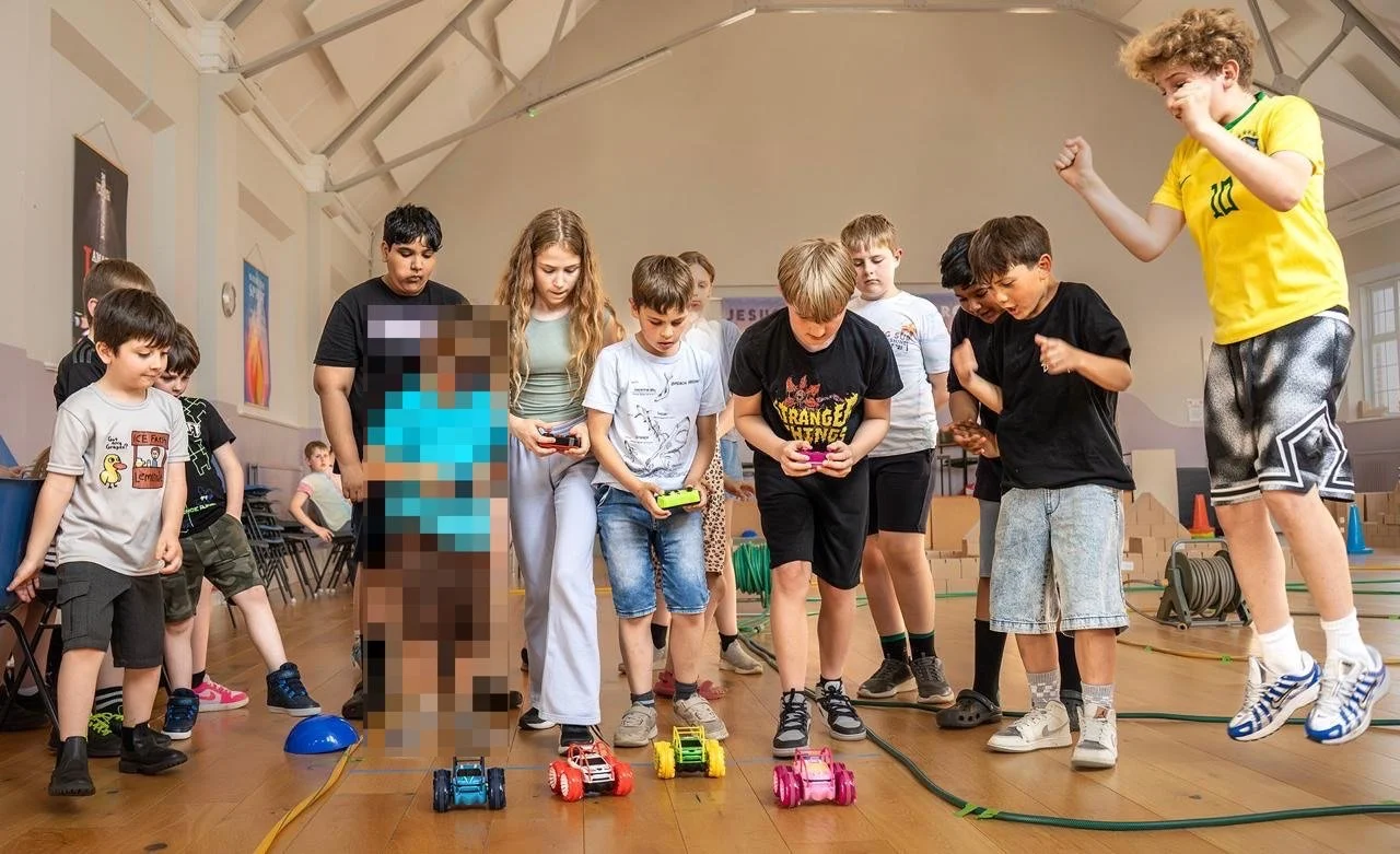A group of children operating remote control cars