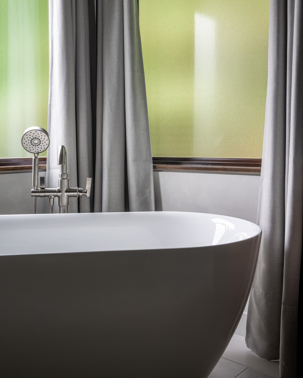 Freestanding bathtub with curtains behind.jpg