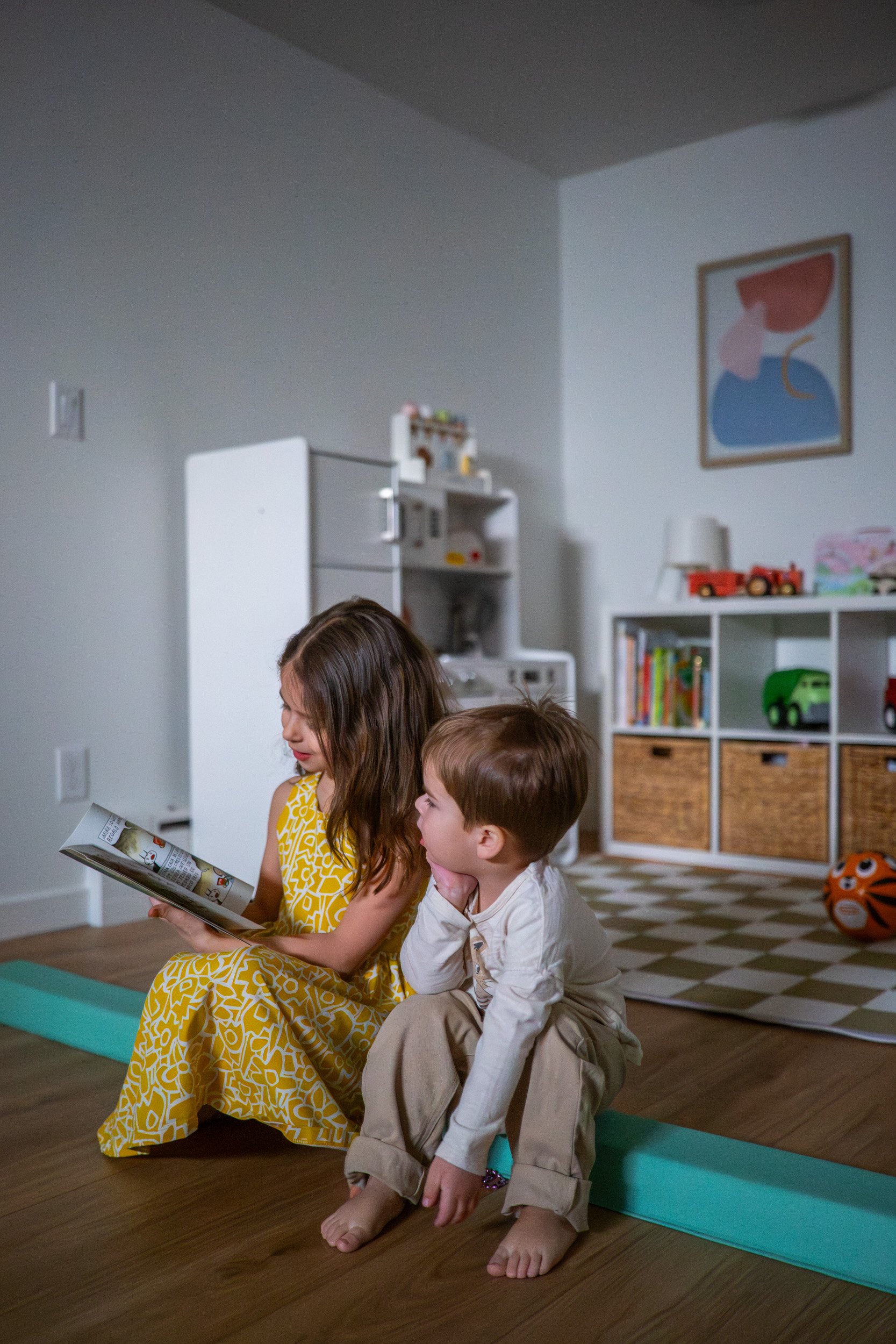 kids reading a book in a playroom area