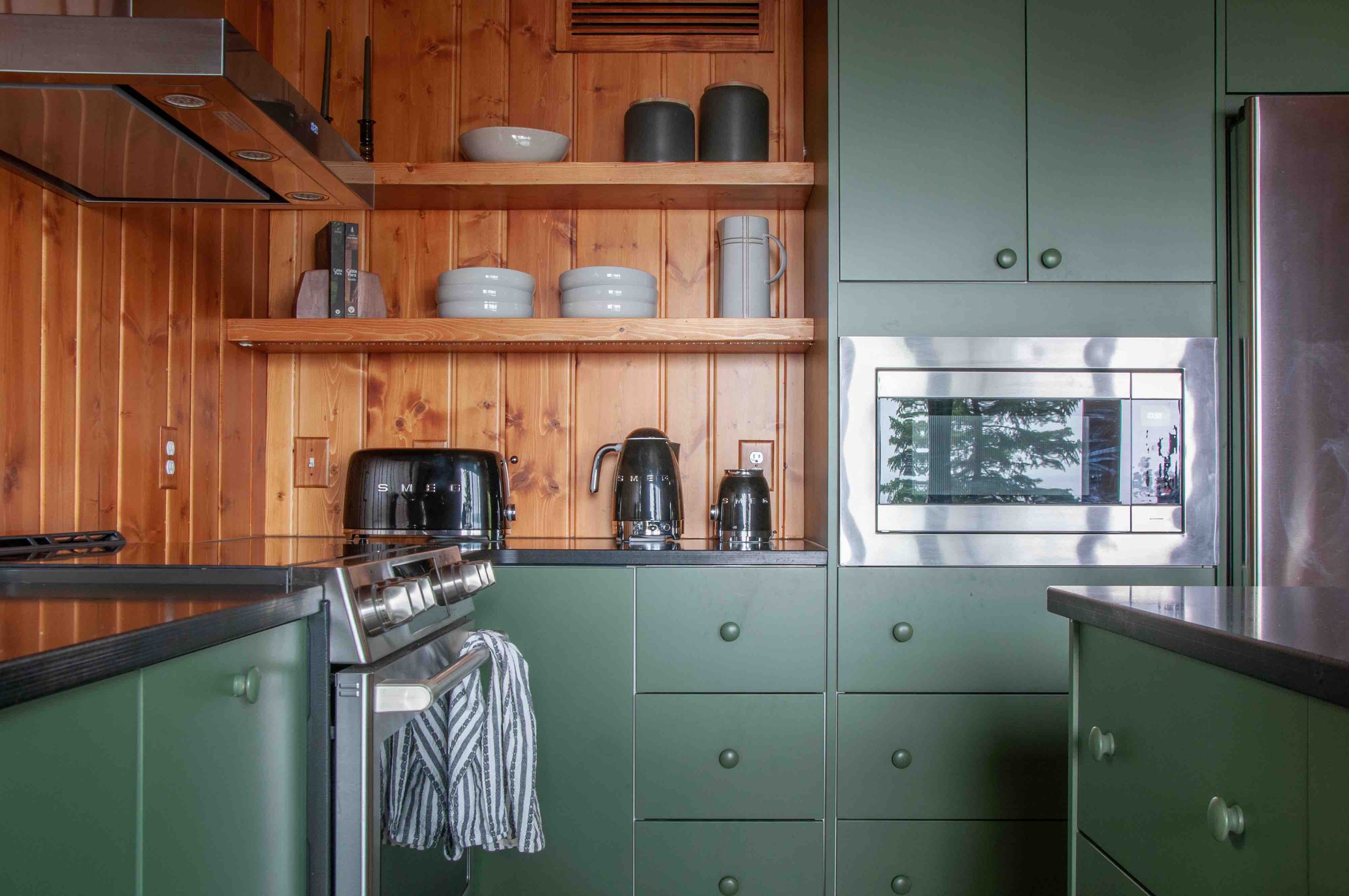 detail of the open shelving in our forest green kitchen