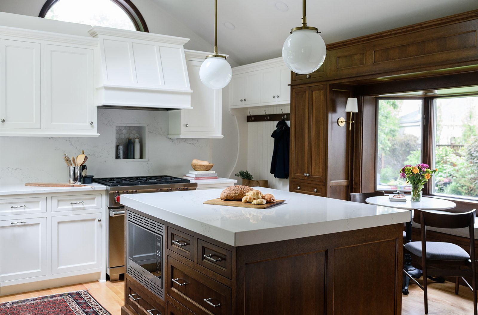 kitchen layout centered around large prep island with integrated microwave drawer