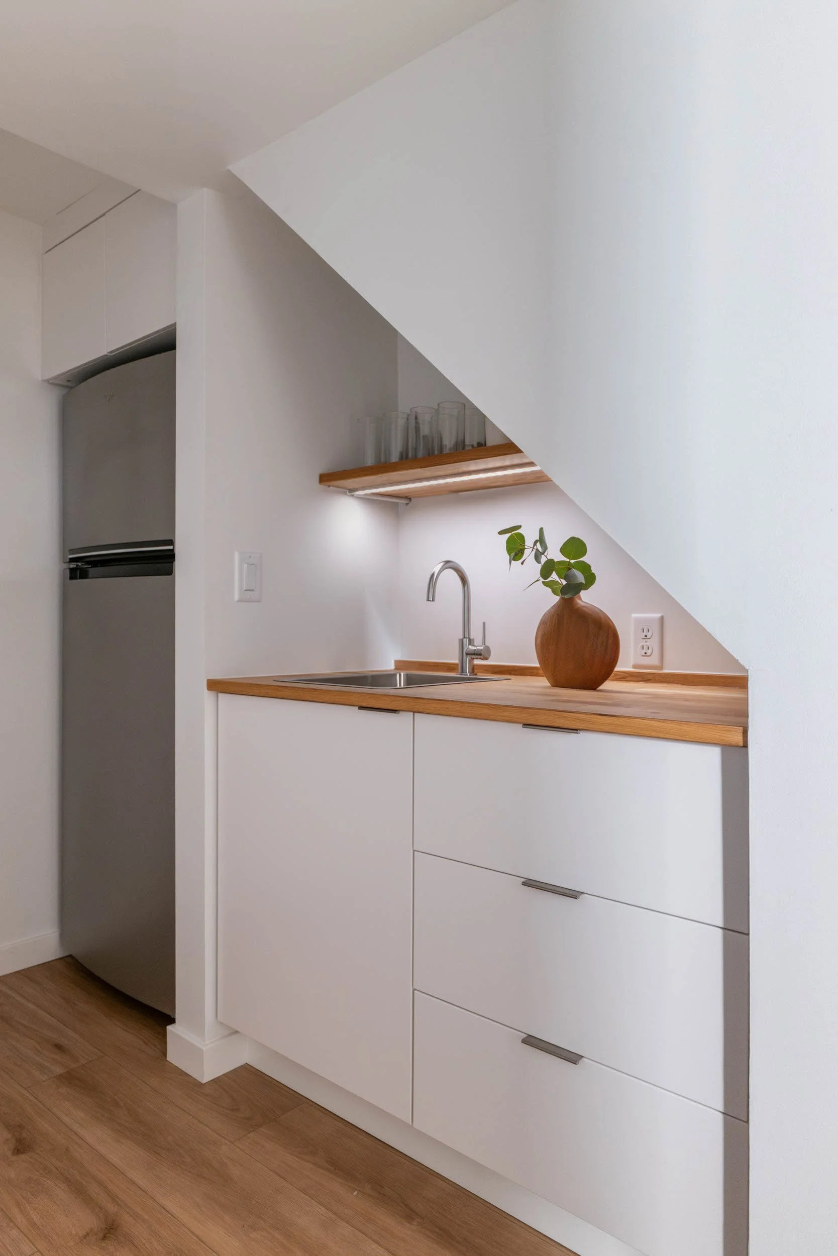 Under stairs wet bar with full size refrigerator