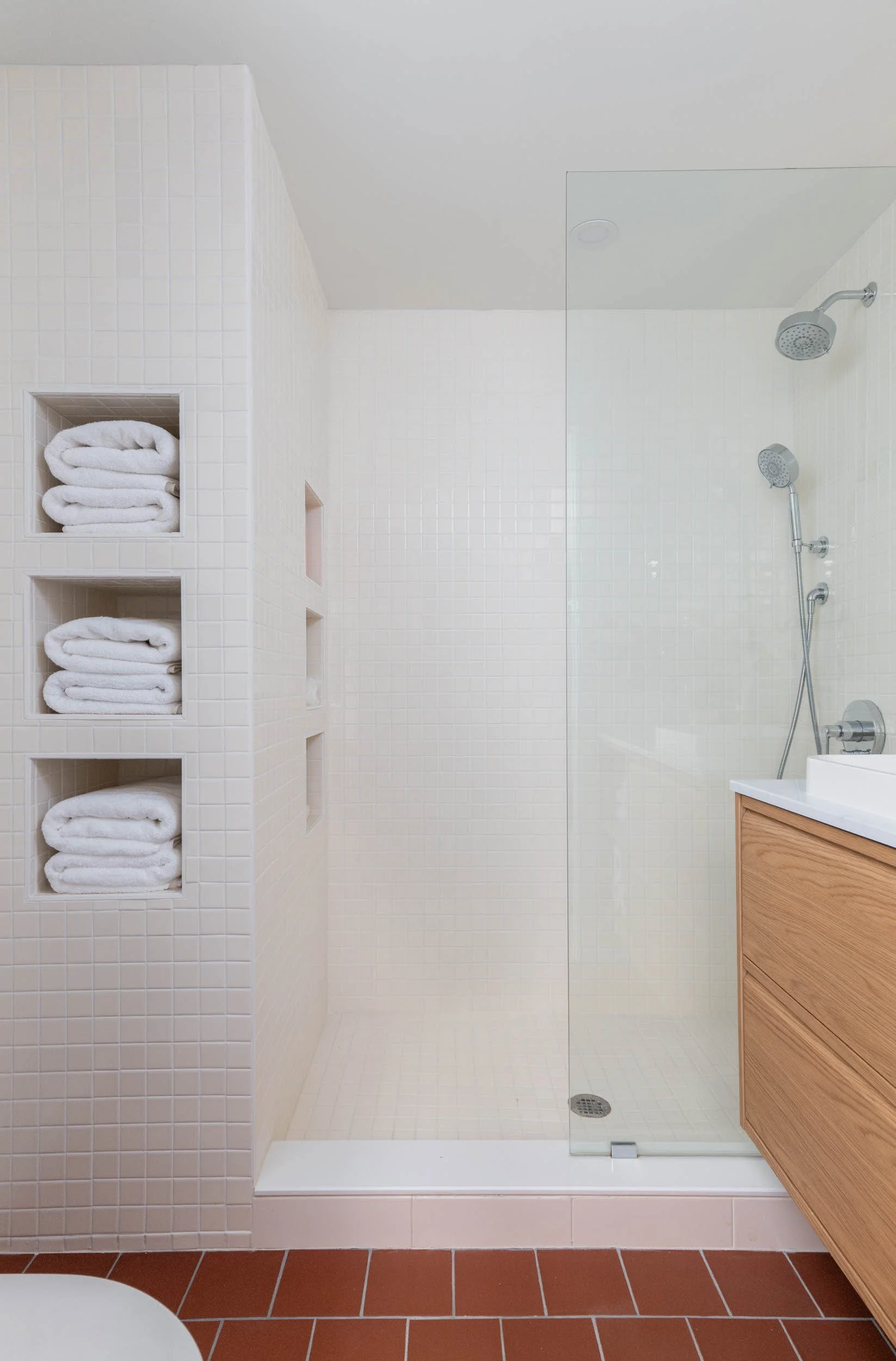 Modern bathroom shower with open shelves for towels