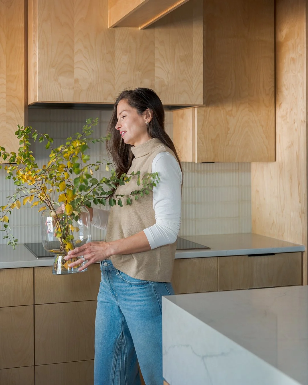 Interior Designer Victoria Johnson walking with a vase