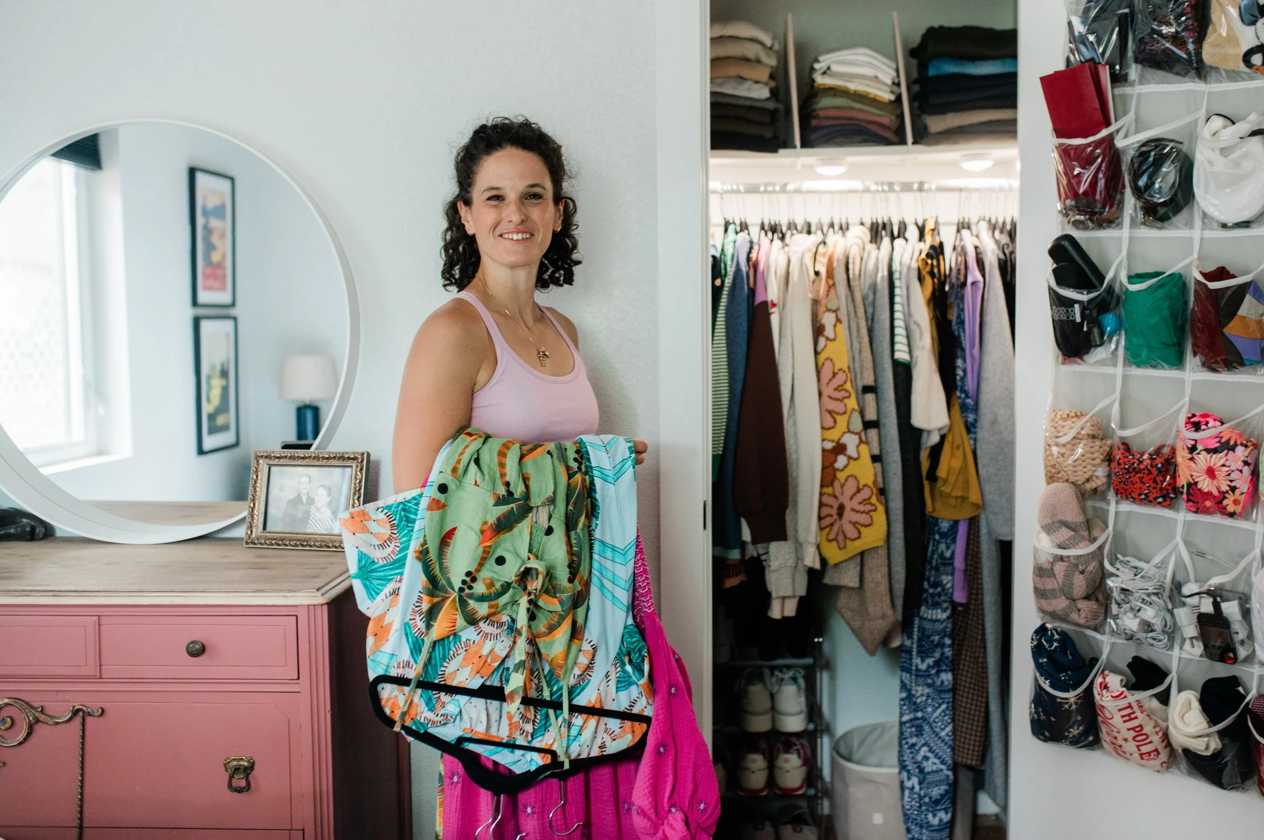 Happy Organized Denver Professional Organizer organizing a small closet in Denver