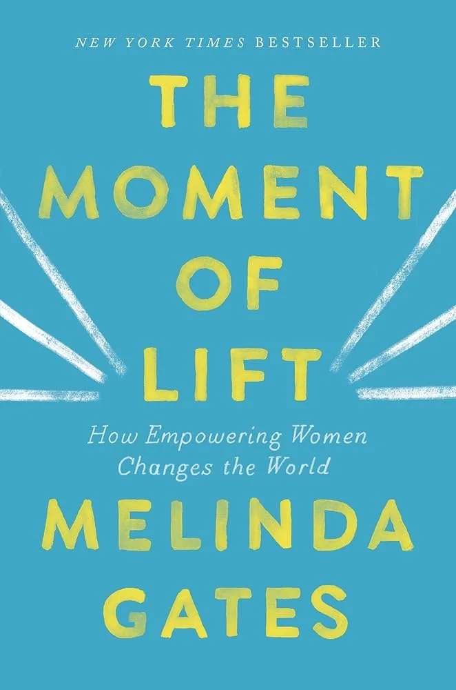 Book cover for 'The Moment of Lift' by Melinda Gates, with a blue background, yellow text, and white rays emanating from the title.