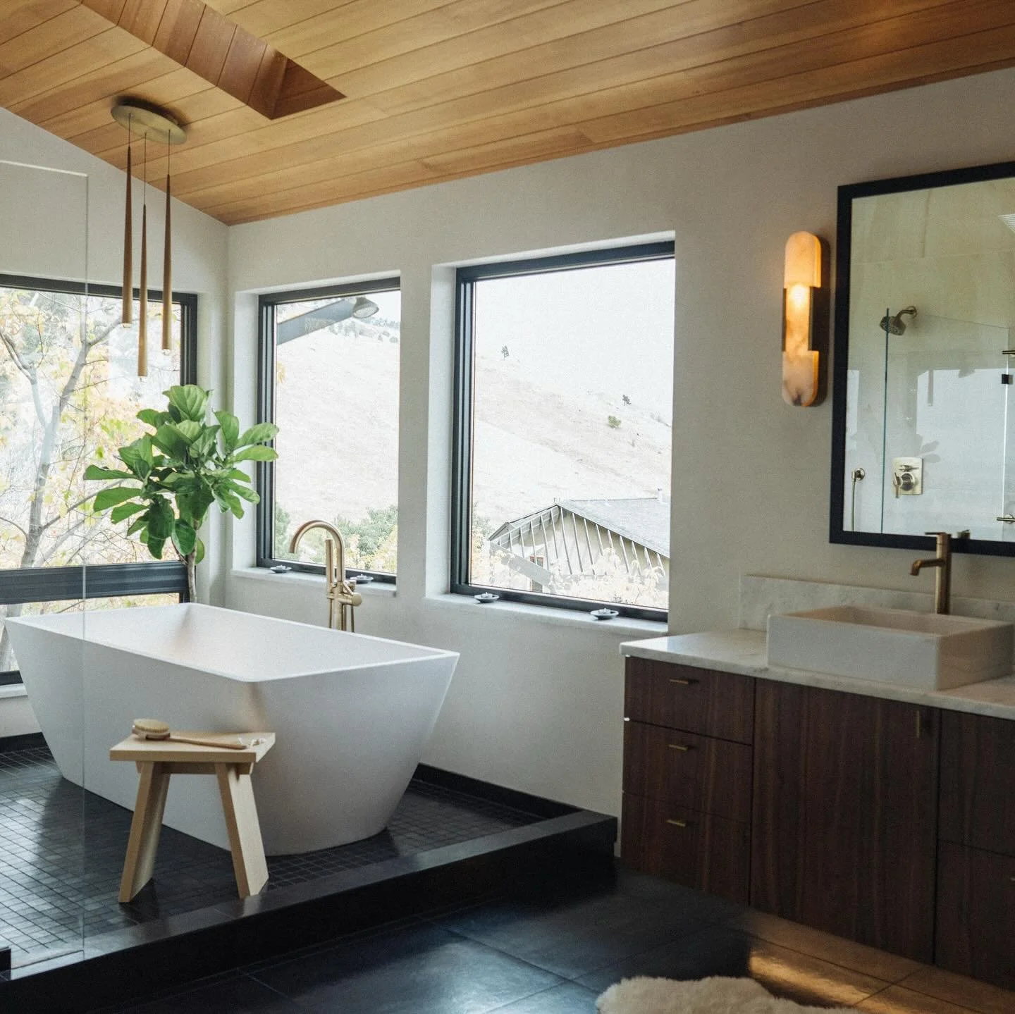 ✨ Luxury meets modern sophistication ✨

This stunning bathroom remodel combines rich walnut wood, sleek dark tile floors, and timeless gold fixtures to create a space that feels both warm and elegant. Designed for relaxation and refined living, every