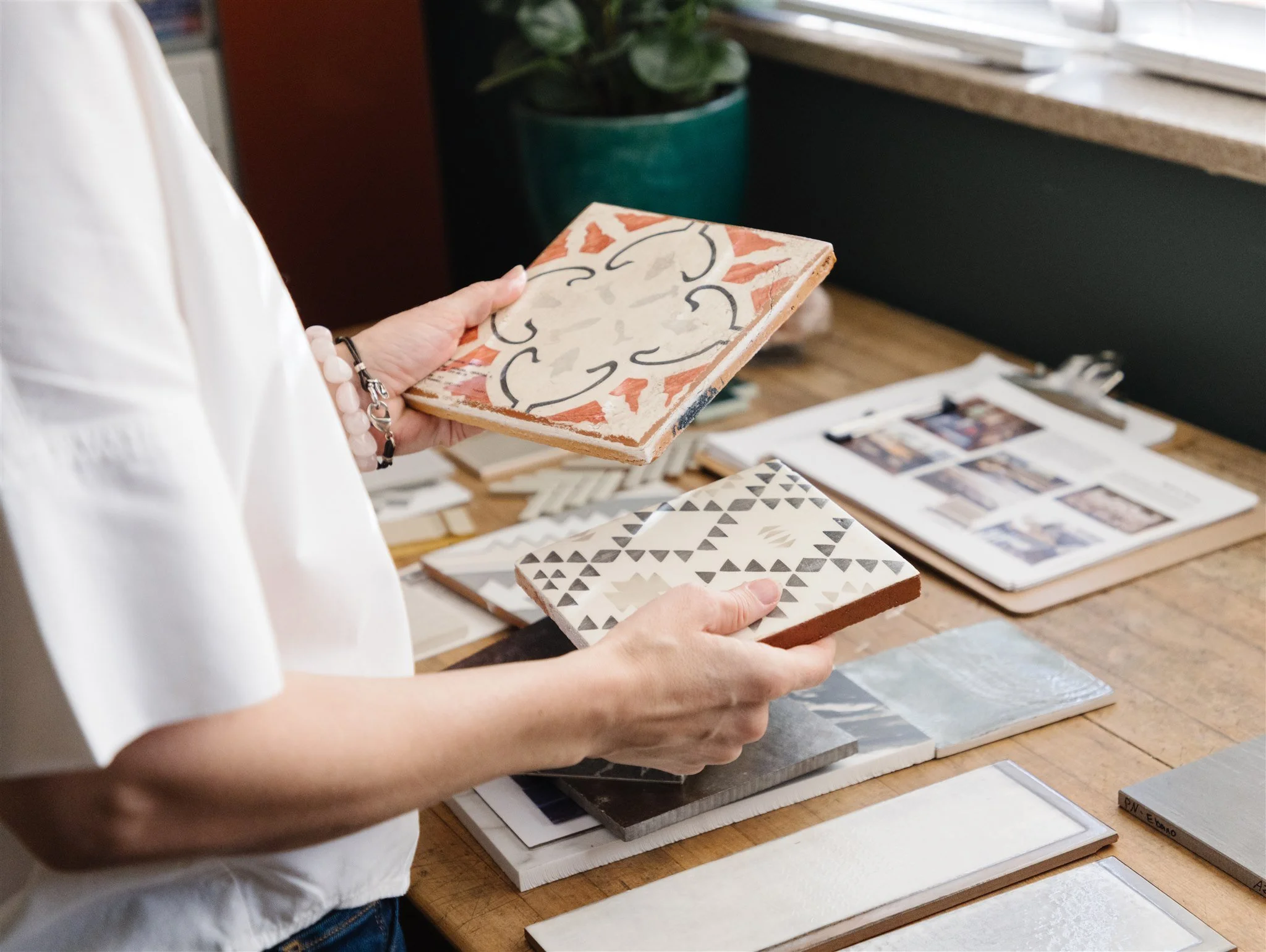 Sara selecting tile samples during a kitchen and bath design consultation.
