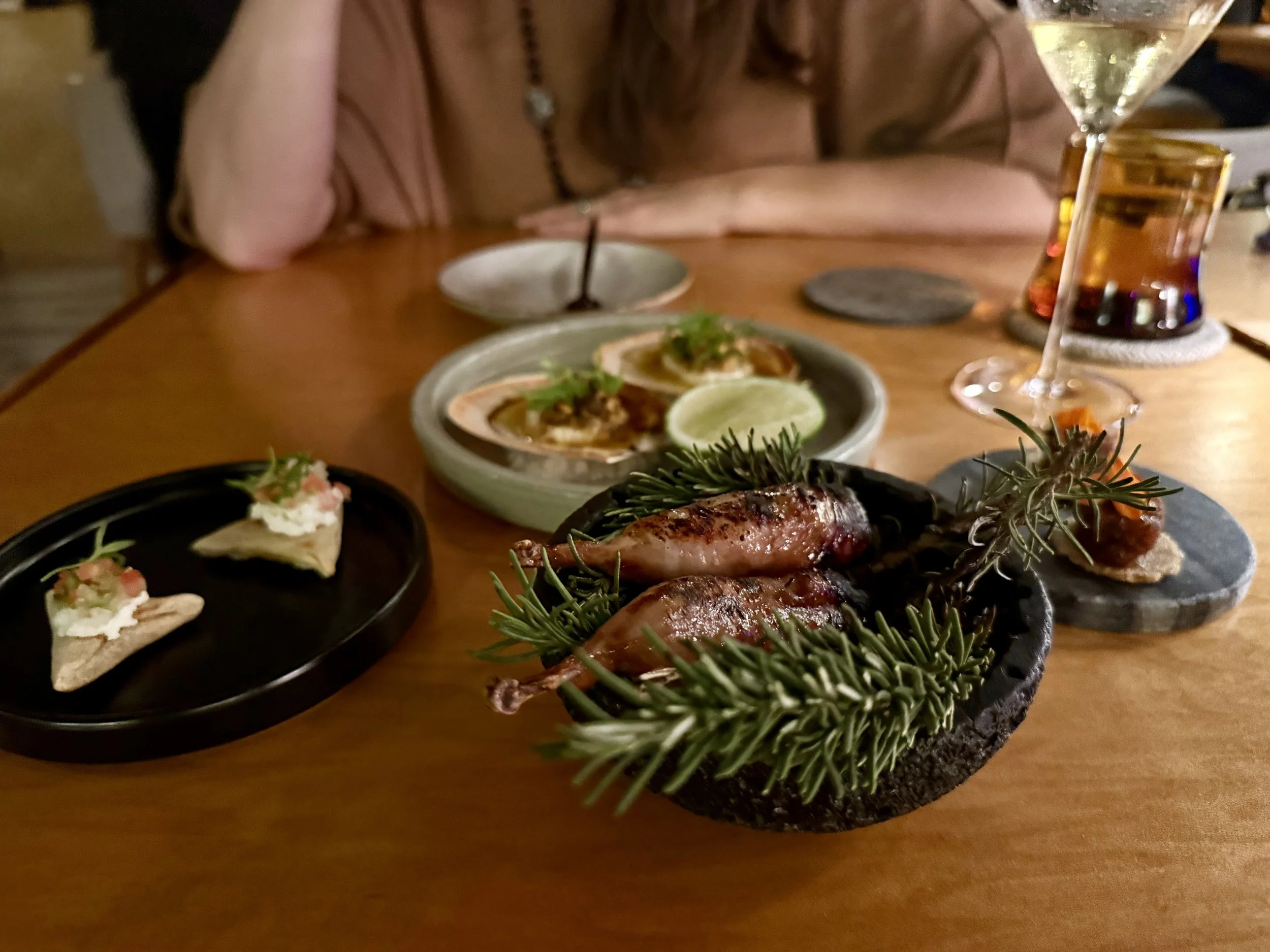 Multi-course tasting menu at Mixtli restaurant in San Antonio presented on handcrafted ceramic plates