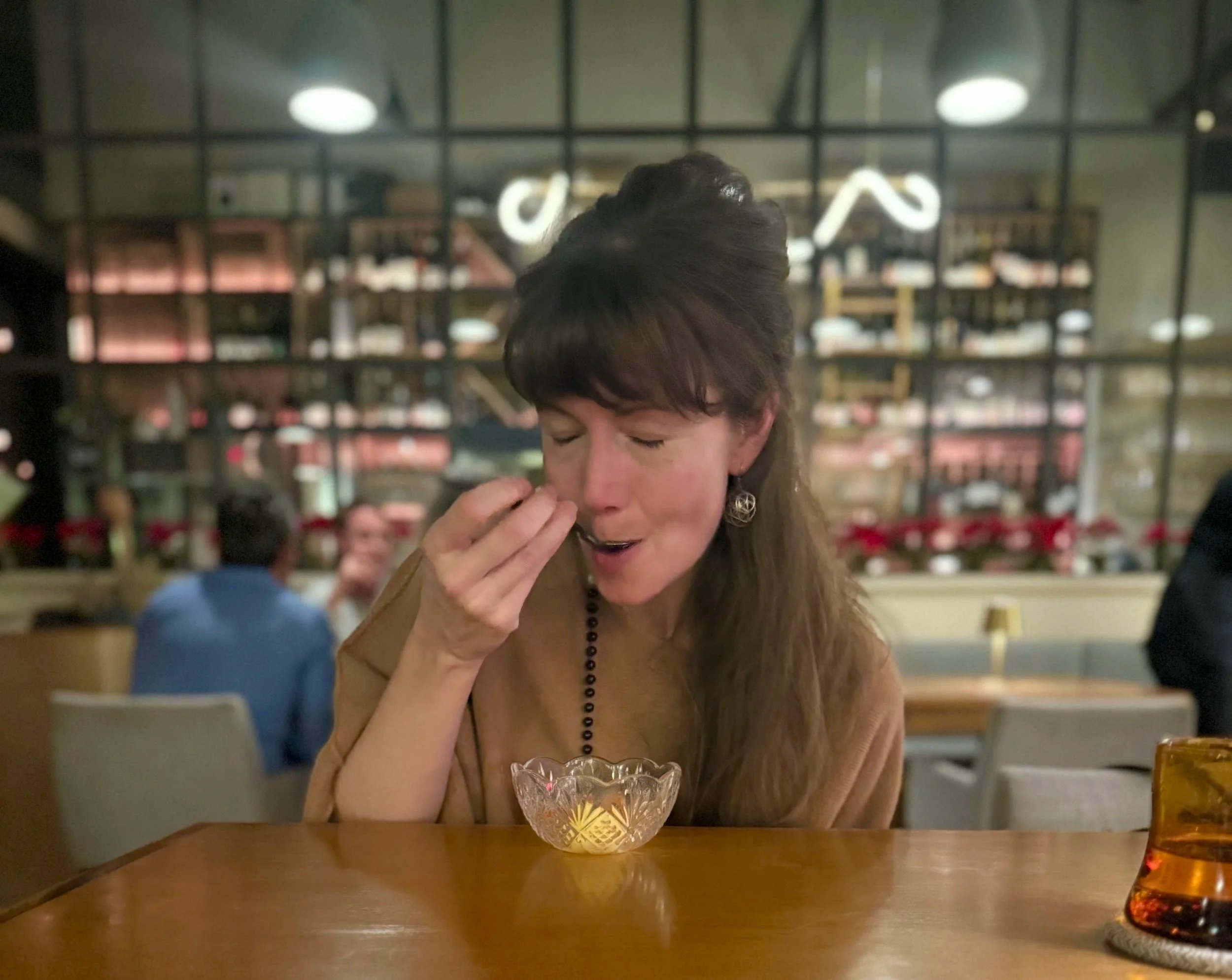 Interior designer enjoying a thoughtfully plated dessert during a fine dining experience in San Antonio, Texas
