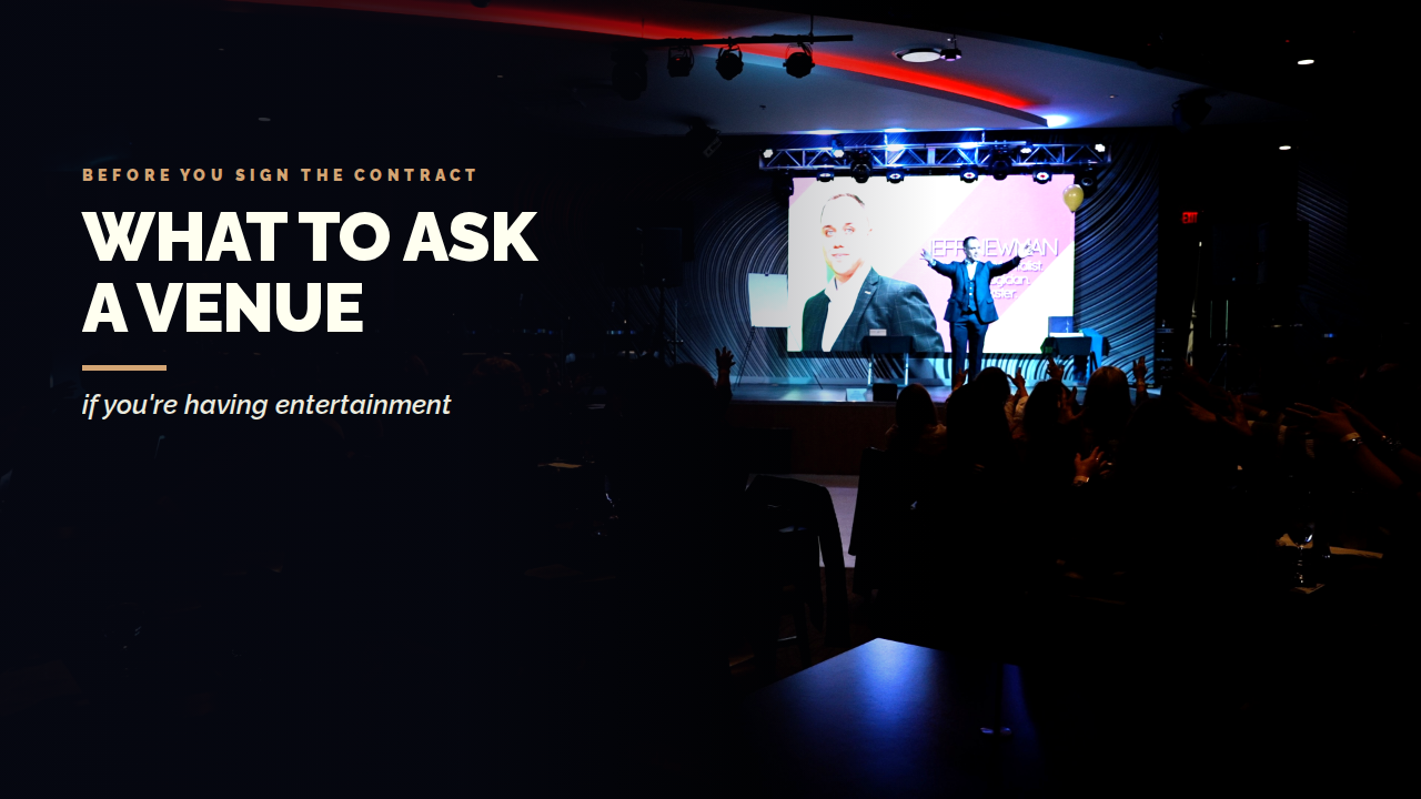 A dark event showroom with truss-mounted stage lighting and a large screen, mentalist Jeff Newman performing for a seated audience, under the title What to Ask a Venue.