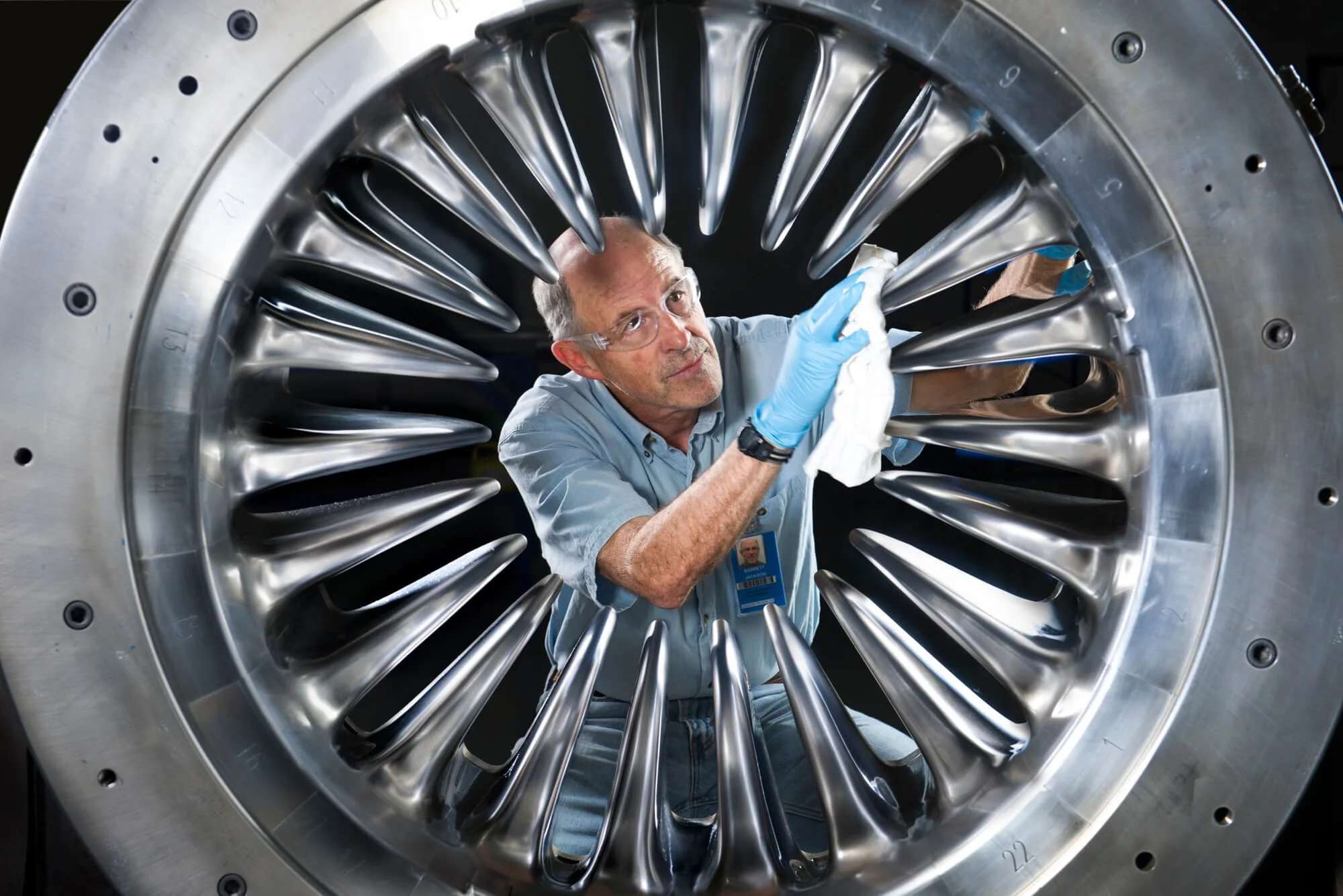 An aerospace technician wipes down a jet engine mold for an aerospace company in San Diego–Ed Carreon Photography