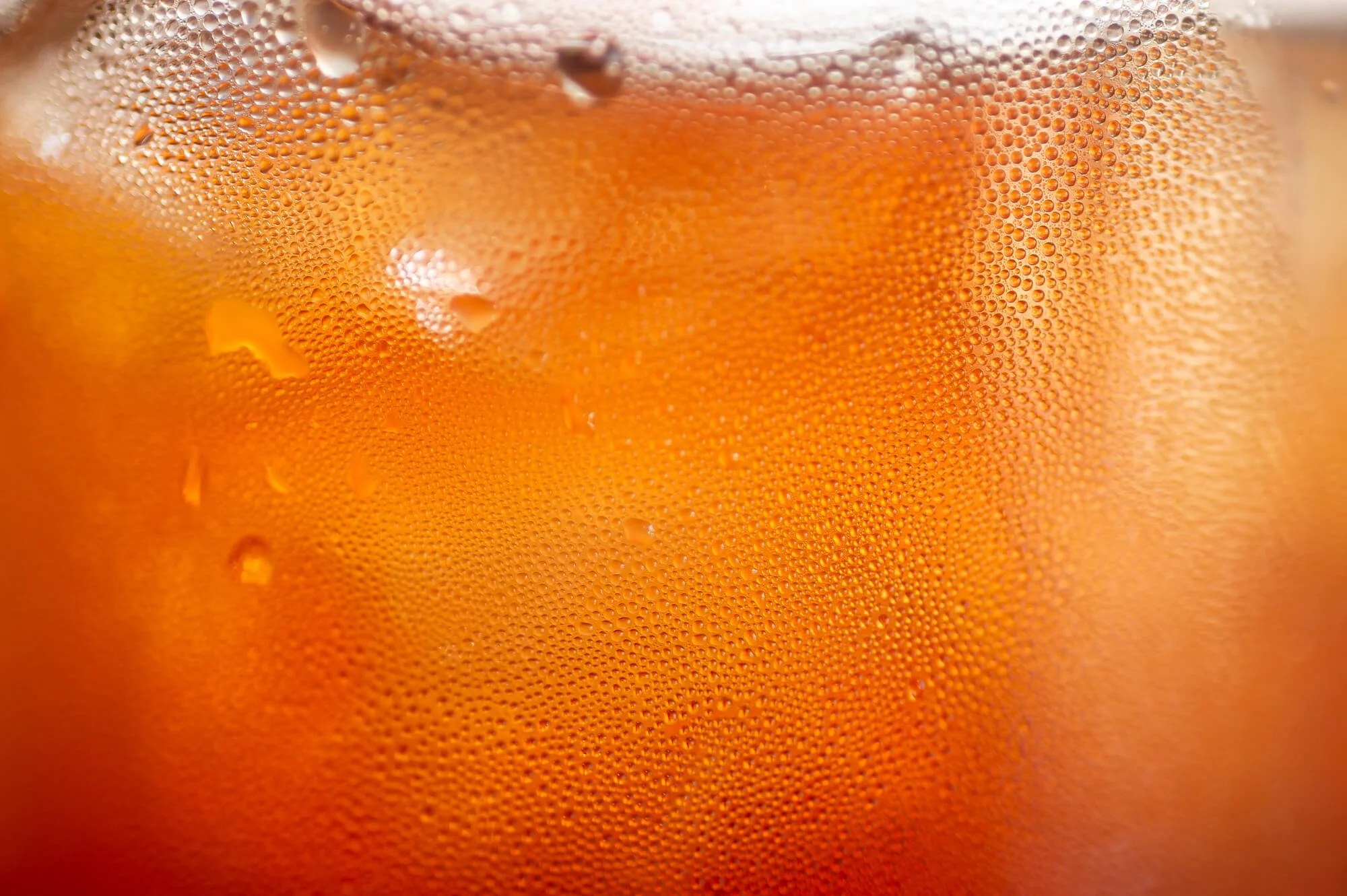 Close-up of a glass of beer with condensation on the surface.