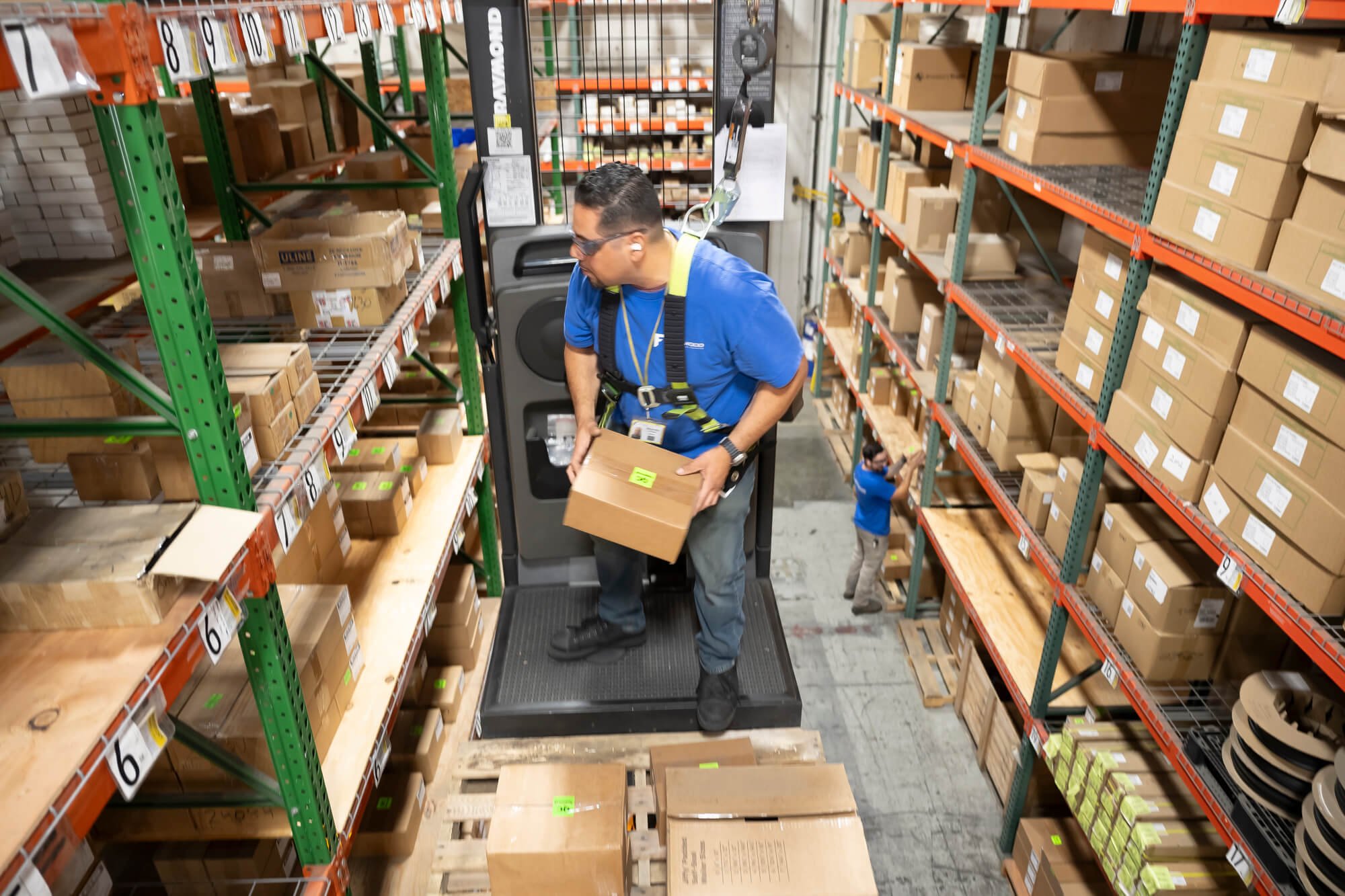 Warehouse worker pulling products on a forklift in San Diego–Ed Carreon Photography