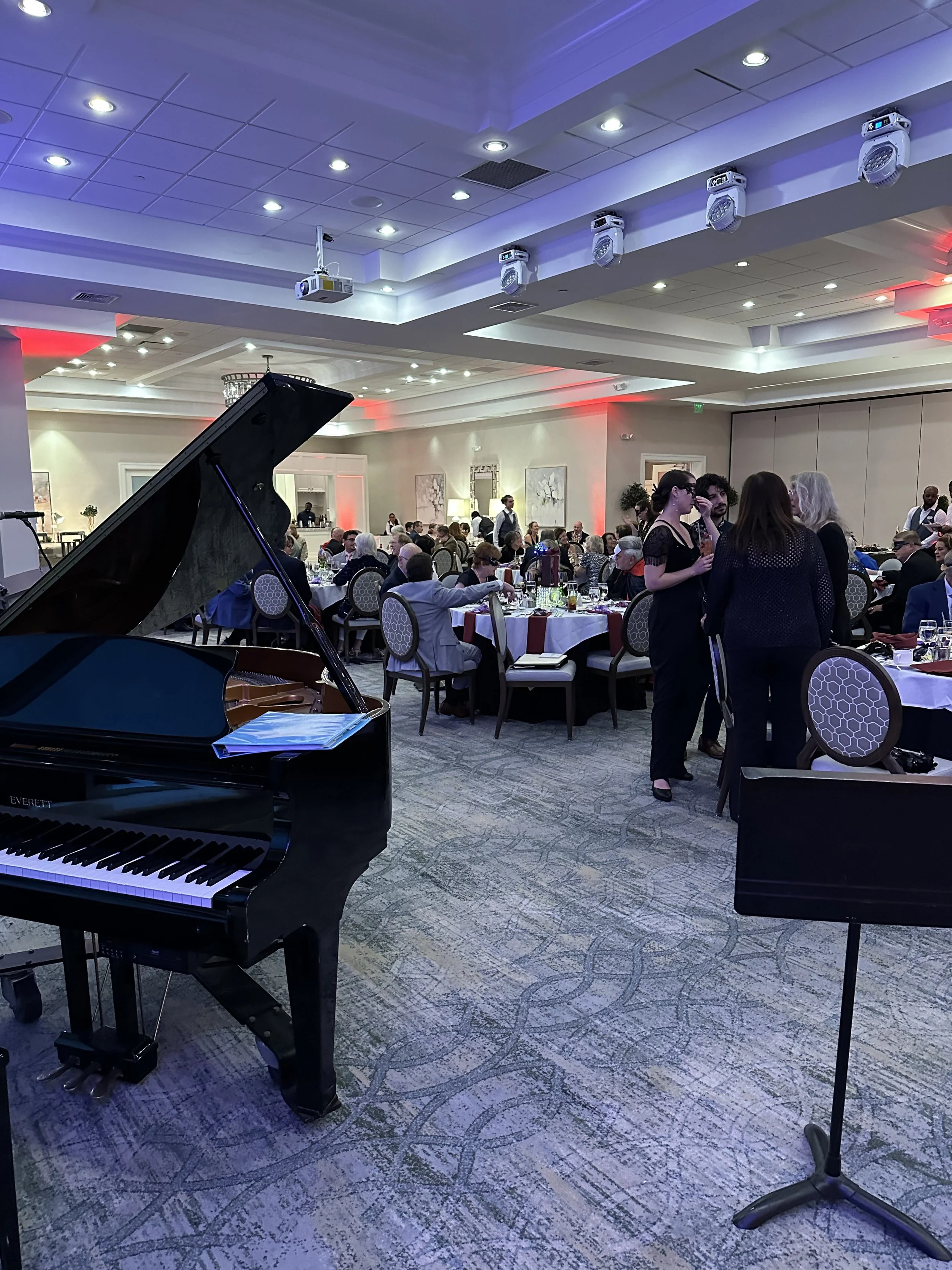 Guests talking and the grand piano