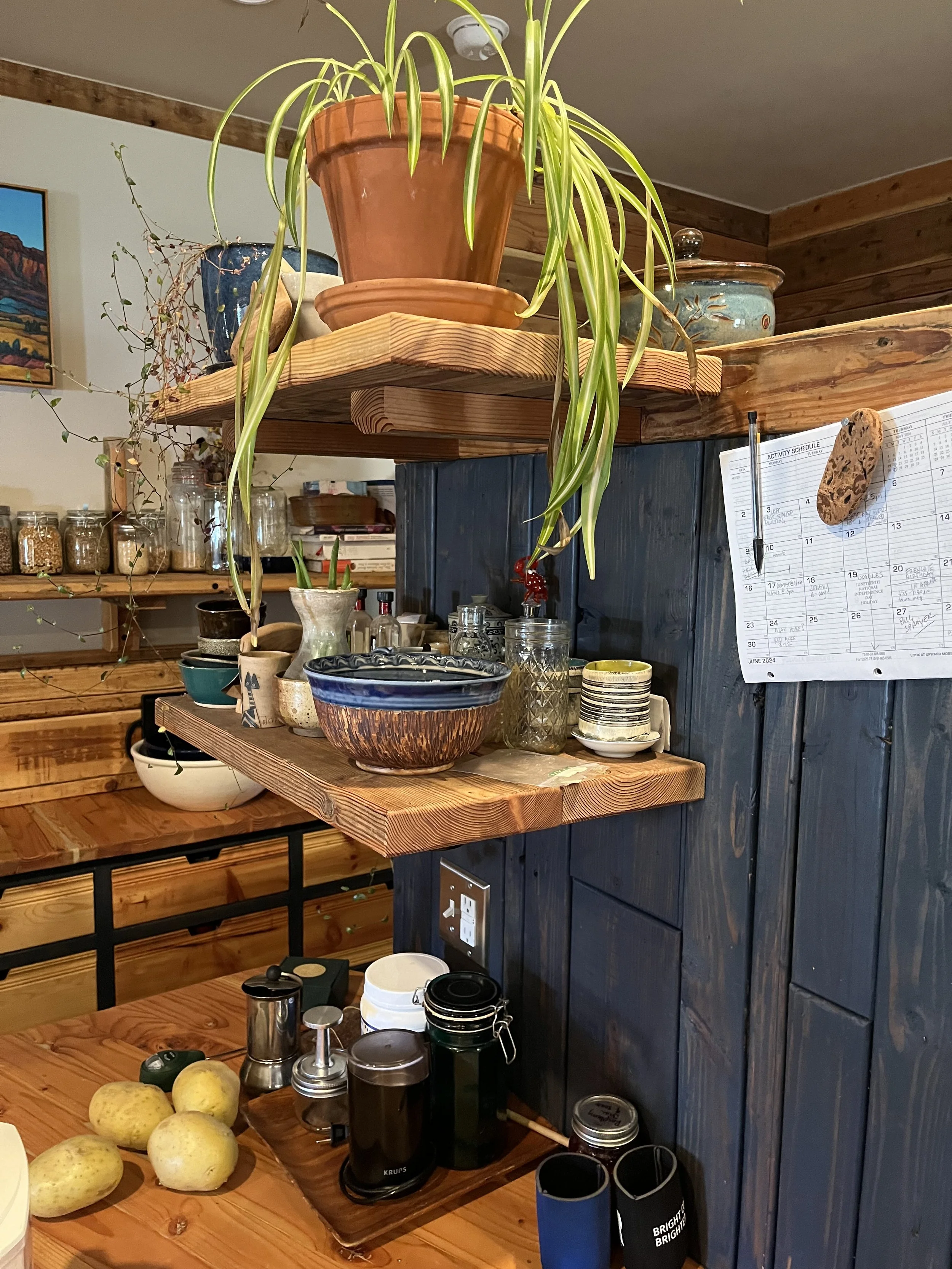 Bespoke kitchen cabinetry made from recycled wood with floating shelves.