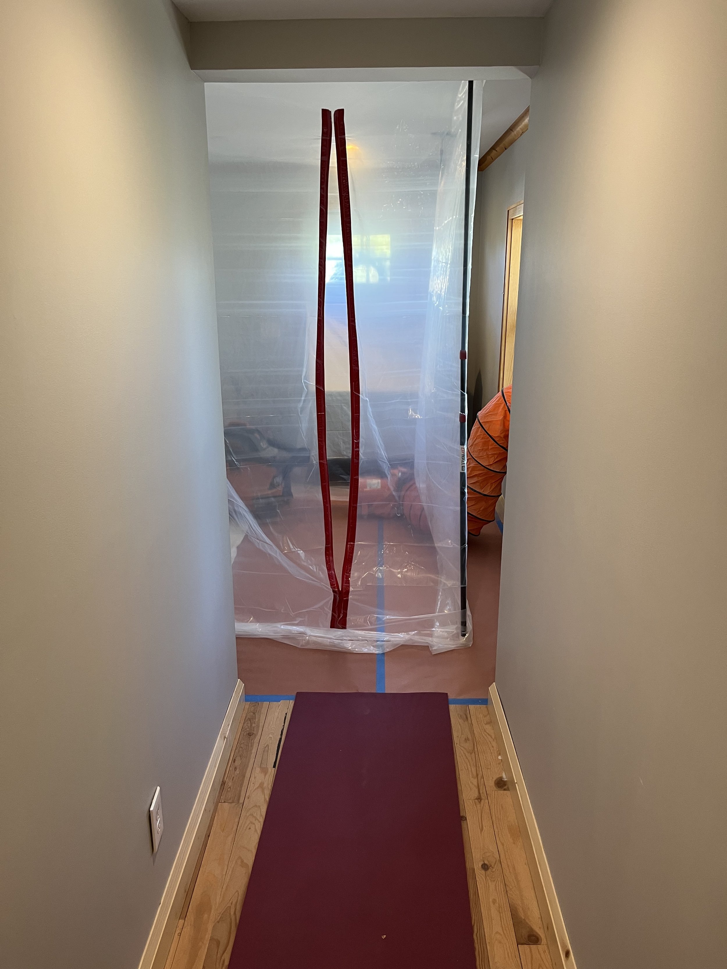 Dust barrier with a zipper wall for entry and exit. Floor protection with a vacuum and a fan with ducting to control air movement and remove dust