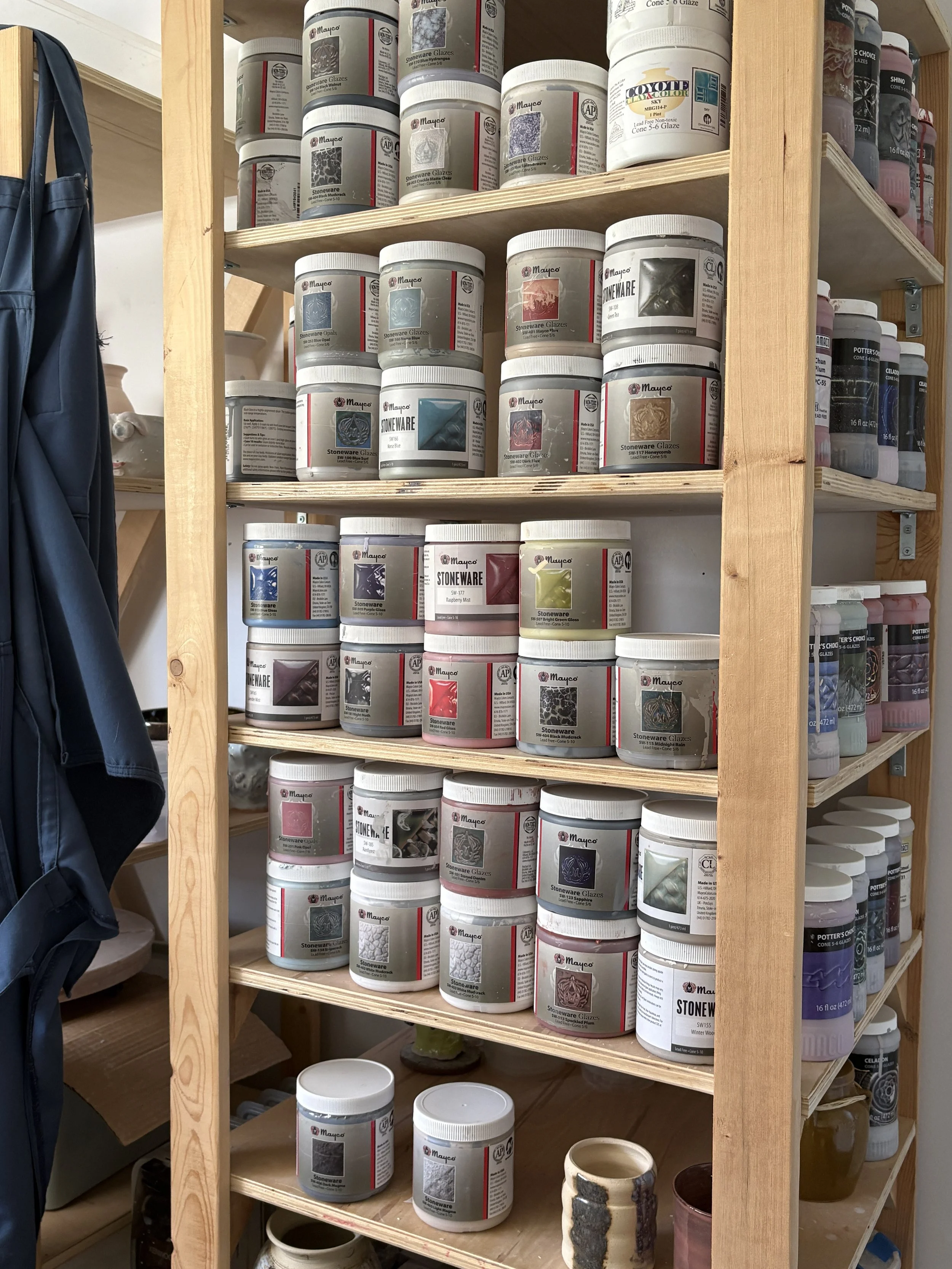 Bookshelf with many Mayco Glazes