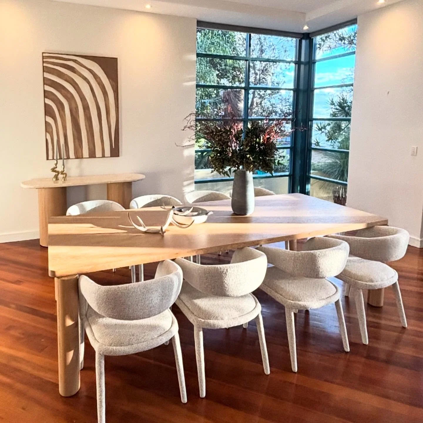 Dining fit for a King! 

Love the different wood tones in this oversized dining room with a beautiful leafy outlook. 

@ellaeliaspropertygroup 
@globewest 
@horganslifestyle 
@florabelle.living 

#dining #diningtable #diningroomdecor #marble #bone #p