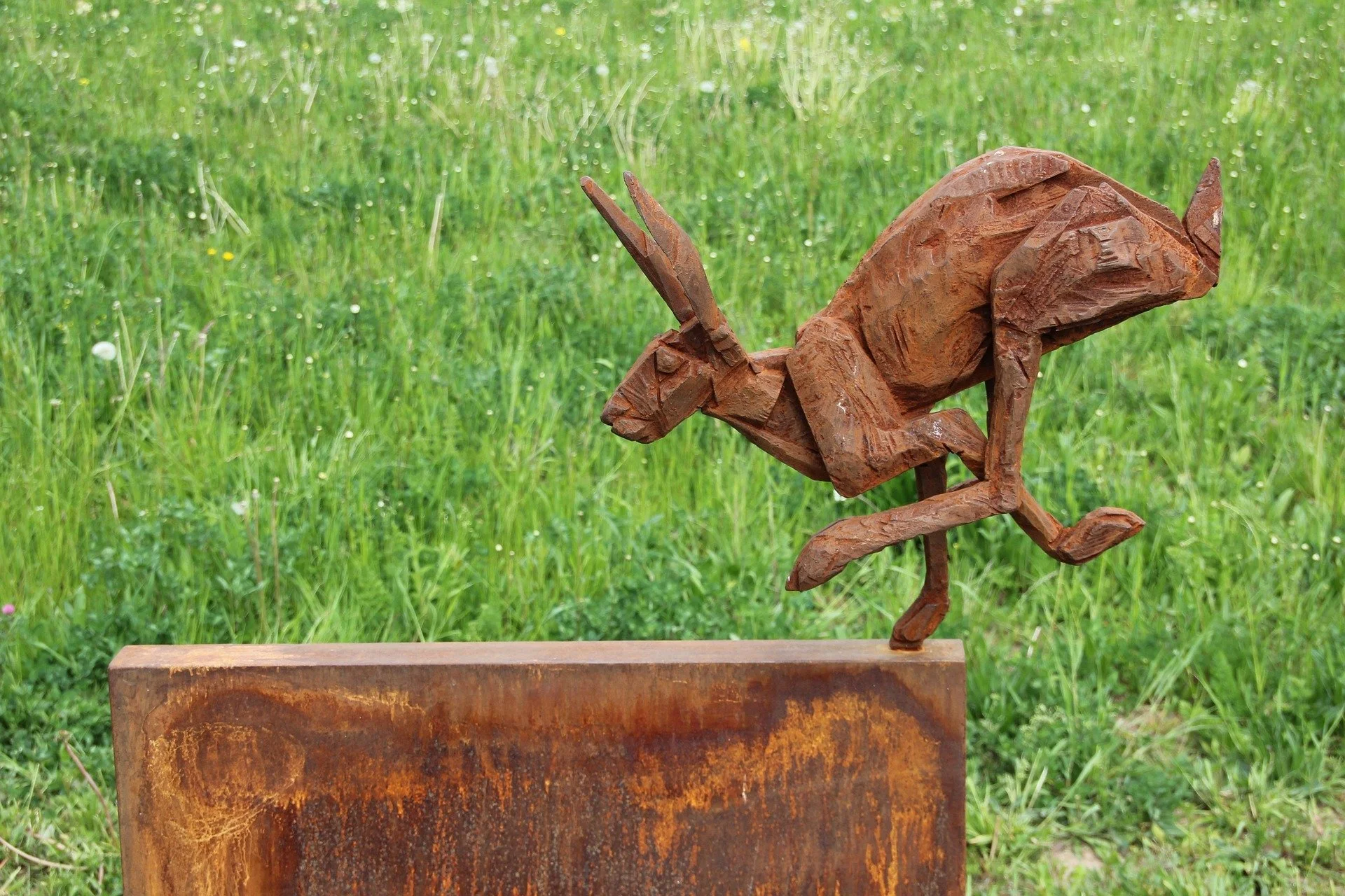 Carved wooden rabbit, running
