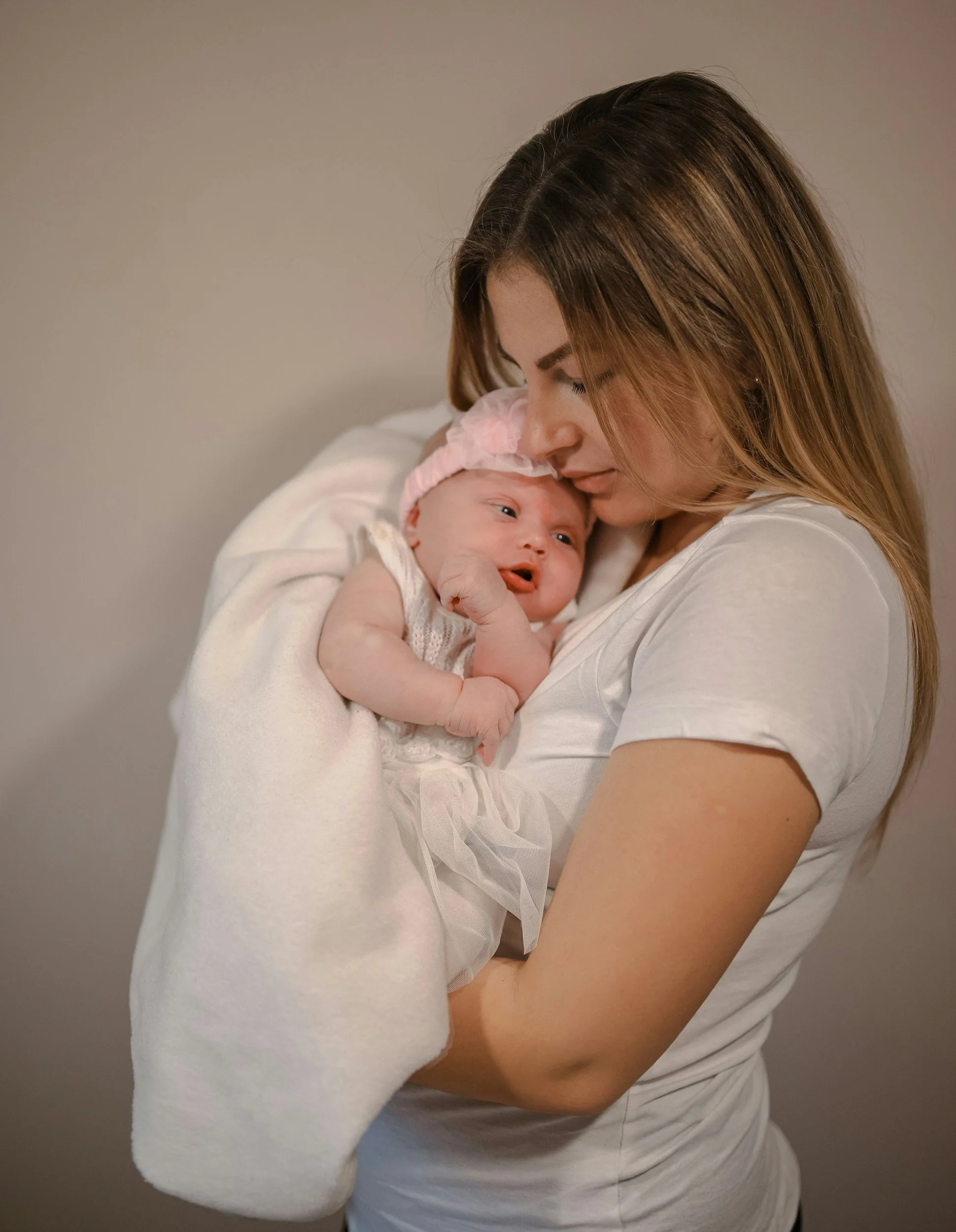 anxious mom holding baby while managing postpartum ocd