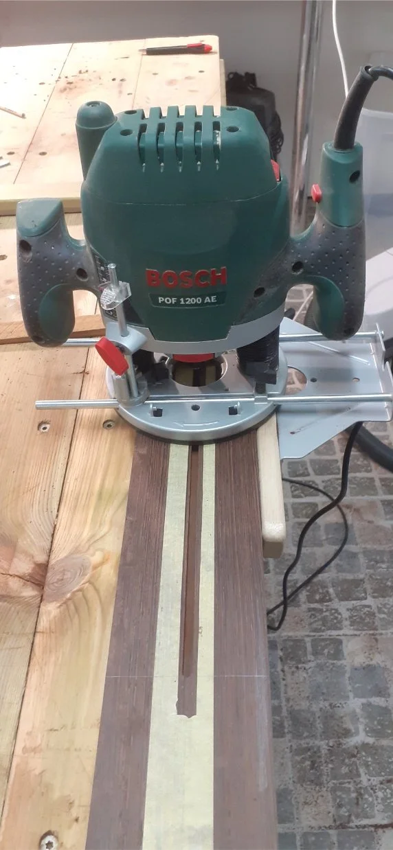 Routing the channel for the truss rod along the centre-line.