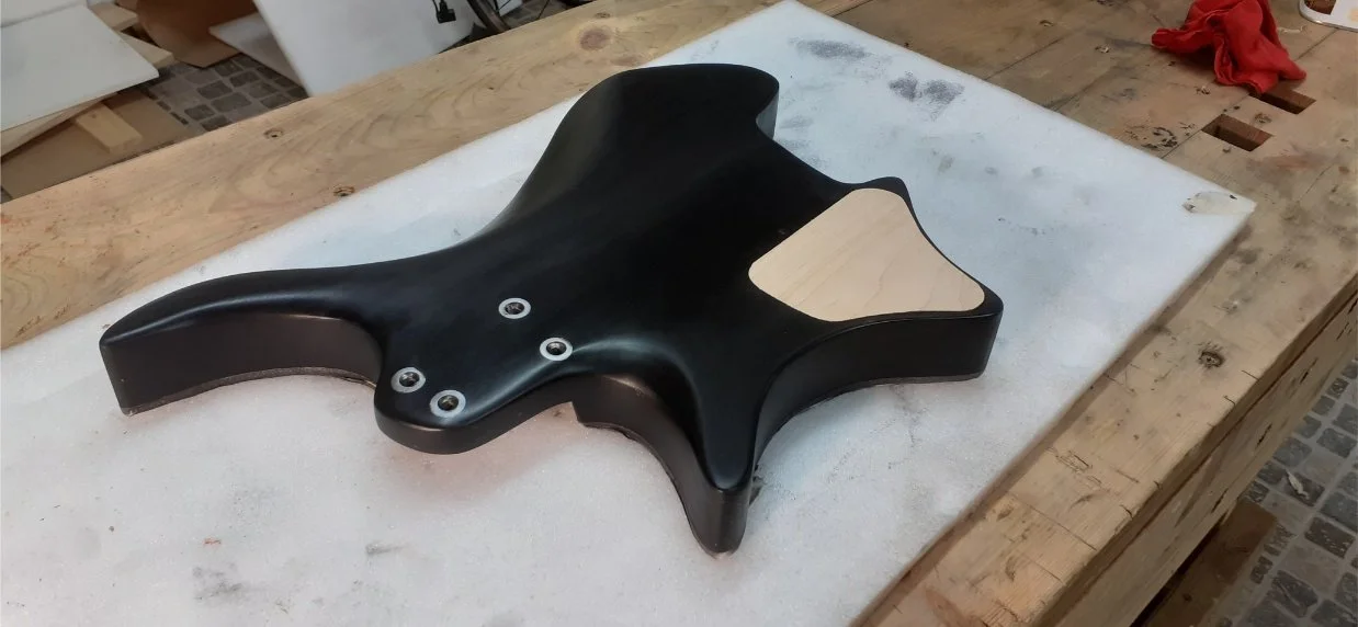 The back and sides of the body was stained black, but leaving the edge of the top unstained. I used gloss Osmo oil over the stain. It looks pleasingly sleek and organic. At this point I had also made the cavity cover from left over maple.