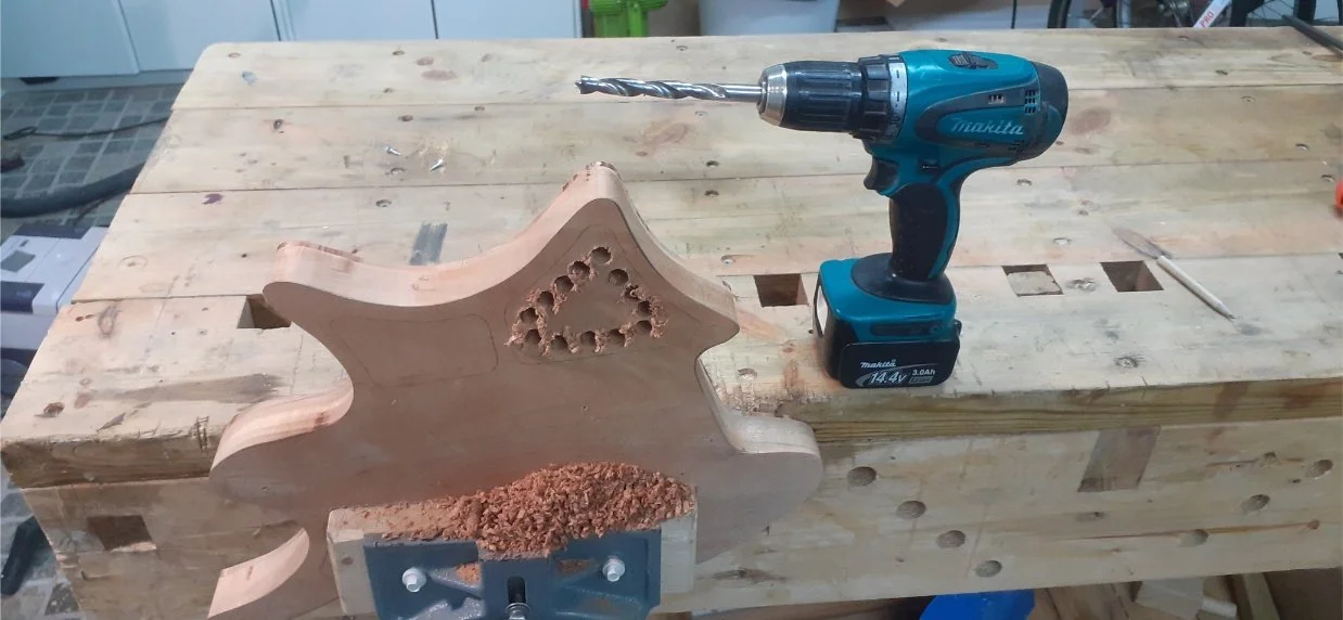 Drilling out the cavity for the electrics. This felt drastic but was fine. On the outside, the hole is covered by the maple top, and on the other side, there is a cover.