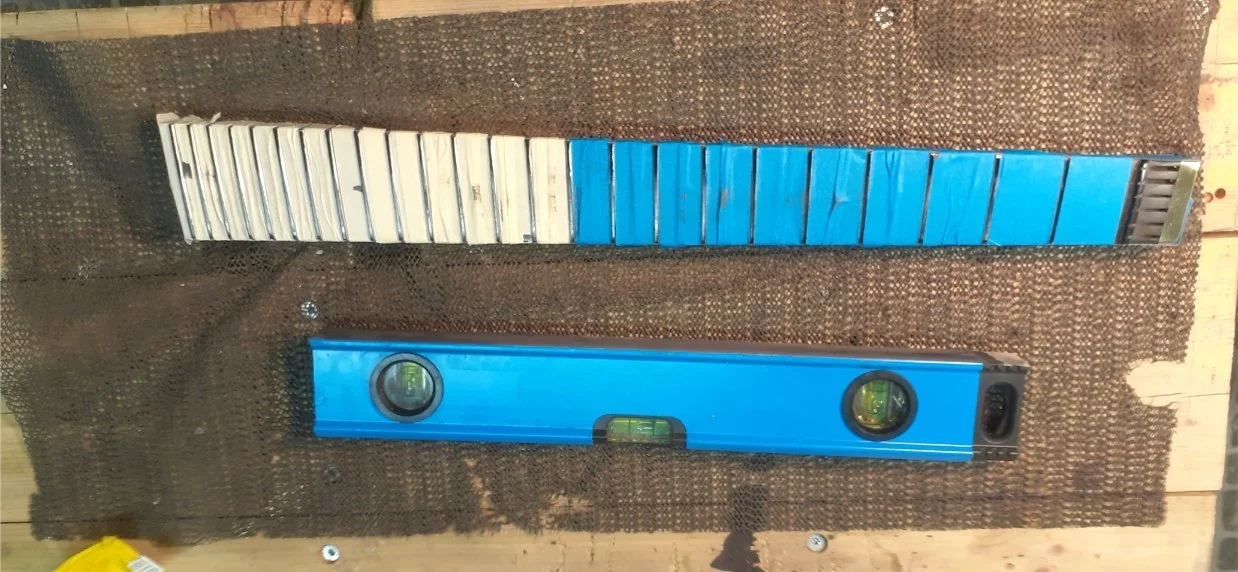Fret levelling with sandpaper stuck to the bottom of a spirit level, which I reckoned was the closest thing to a levelling beam in my workshop. This was hard work, largely because I had done a poor job installing the frets so they needed a lot of lev
