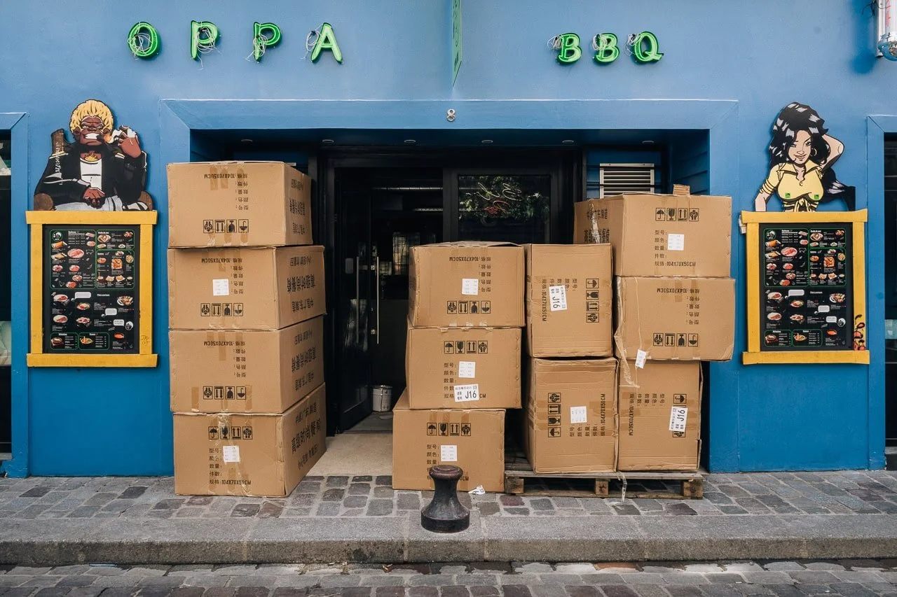 Delivery boxes stacked outside an Asian BBQ restaurant in Paris, France