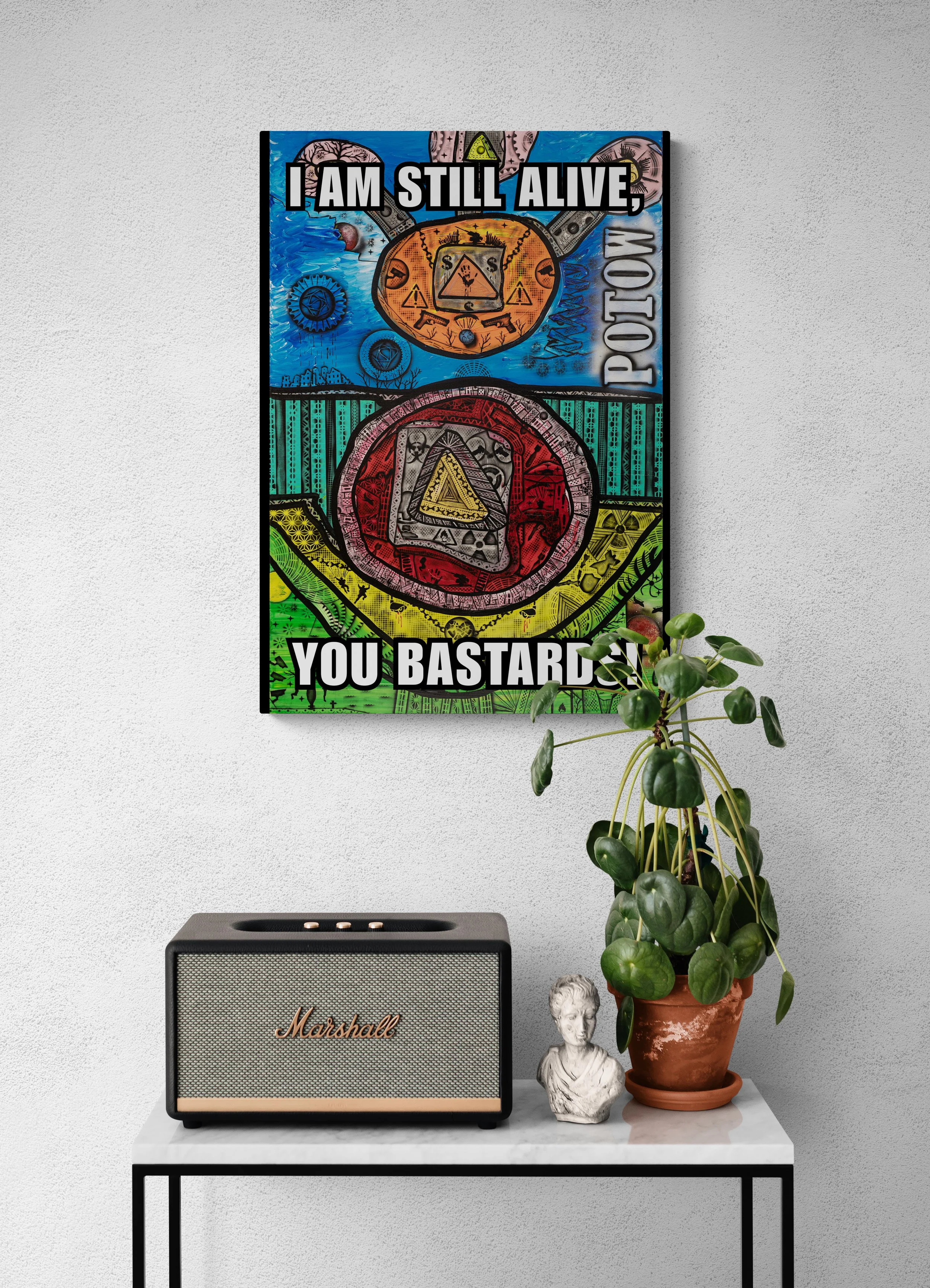 A colorful pop art-style poster with a bold message about surviving an explosion, with a universe and grenade illustration, hanging on a white wall above a white table. The table holds a black Marshall speaker, a small classical bust, and a potted plant with green leaves.