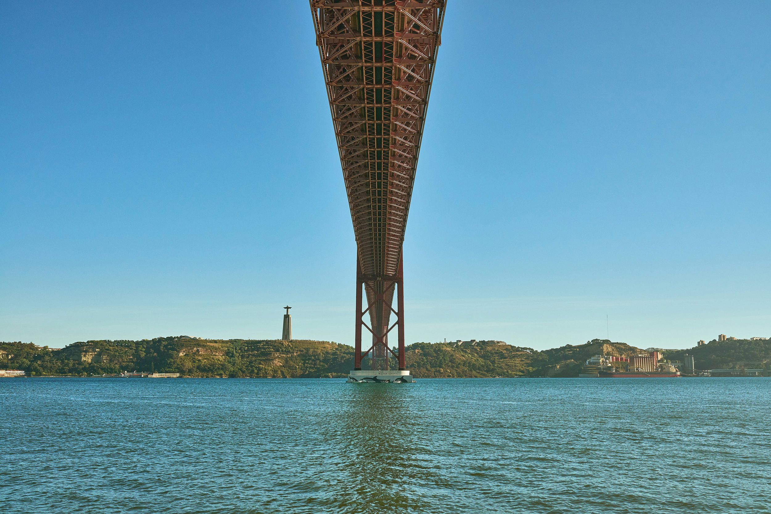 Underneath the 25th of April bridge, one of the epic views on our self-guided audio adventure by bike from Lisbon to Belem