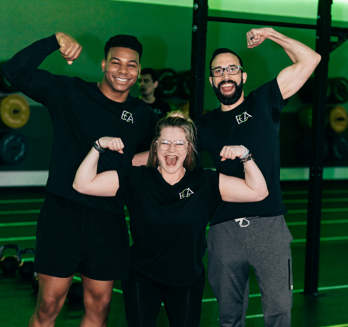 Personal training and gym member perform planks at our spacious fitness center. 