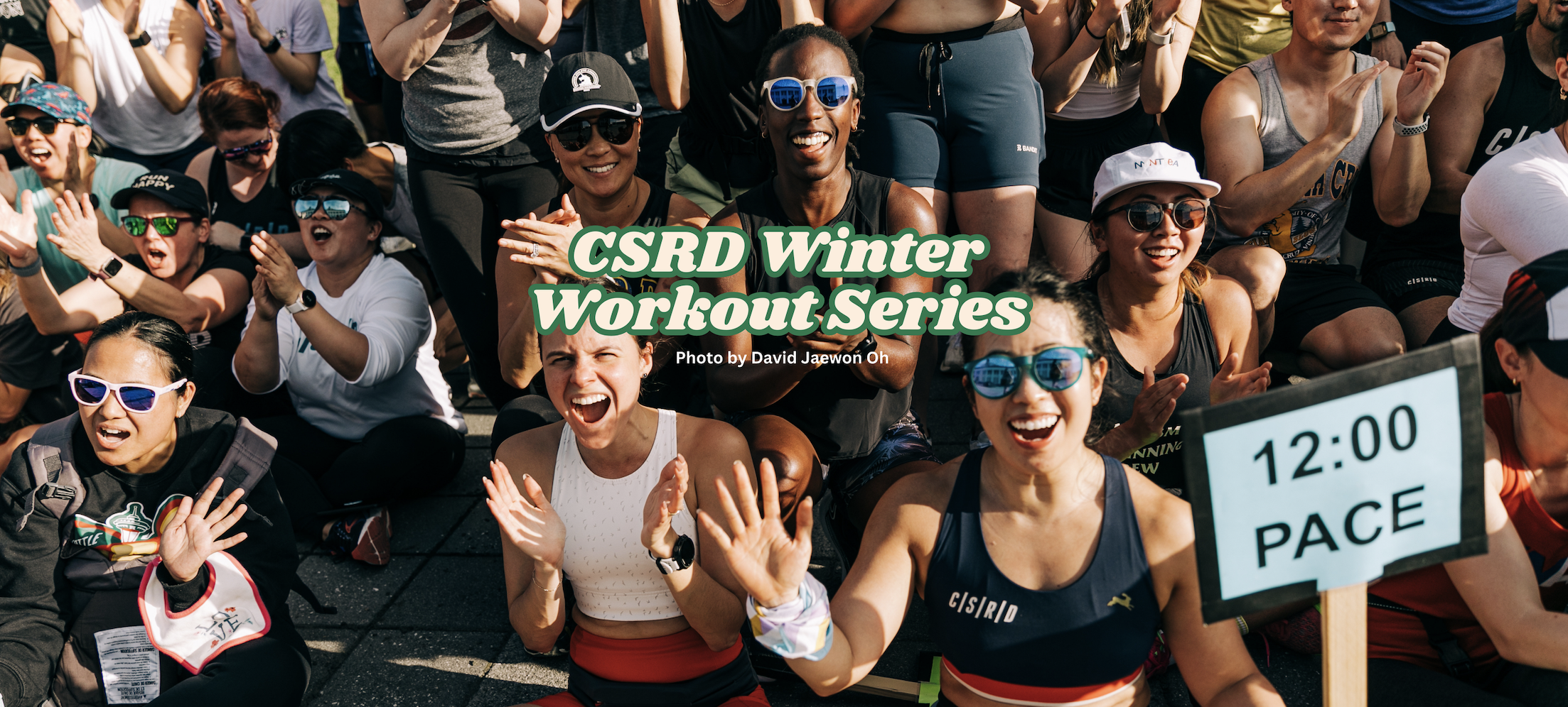 Group of people clapping outdoors with "CSRD Winter Workout Series" text overlay, 12:00 pace sign