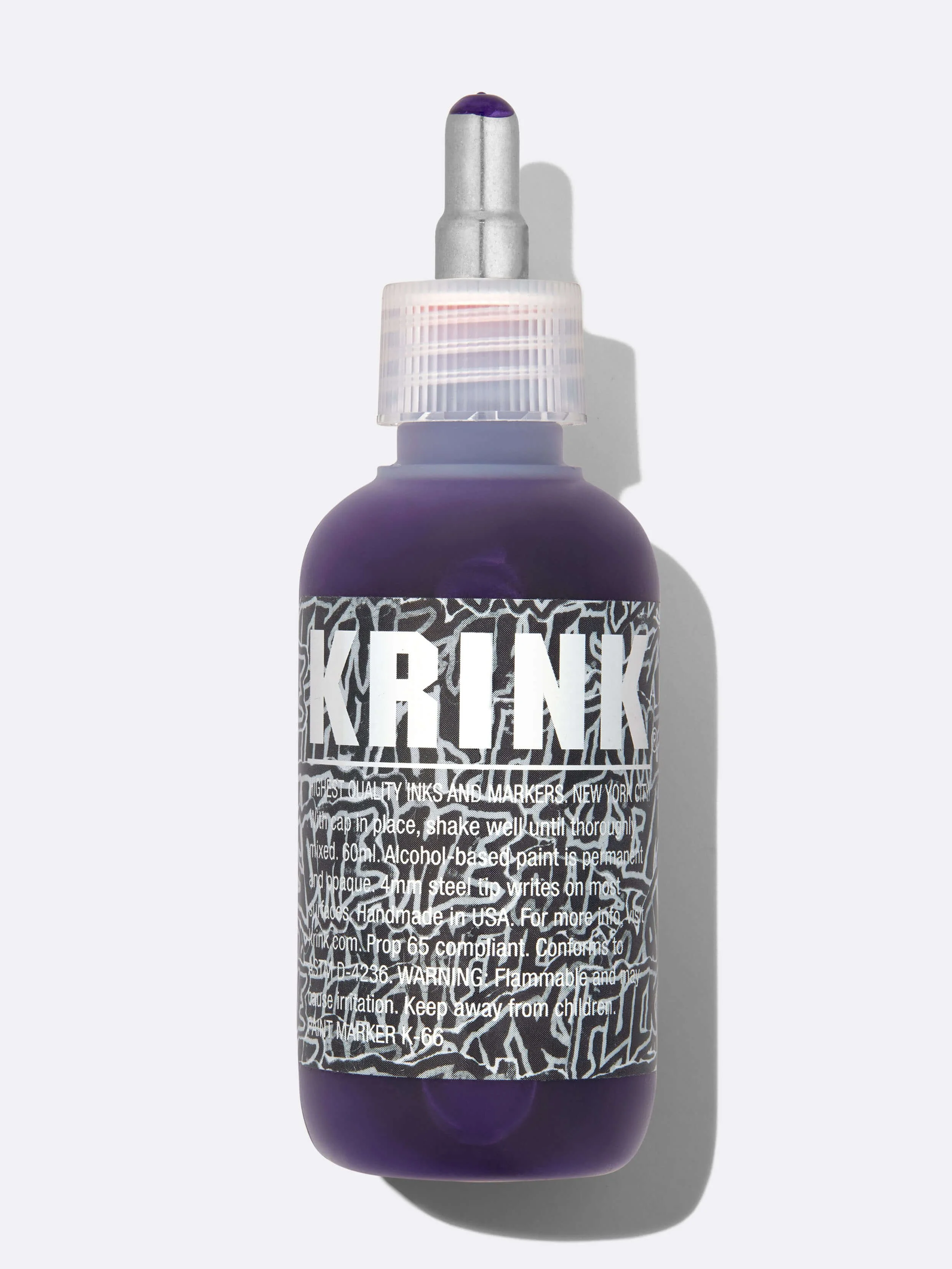Professional product photography of purple Krink marker bottle on white background