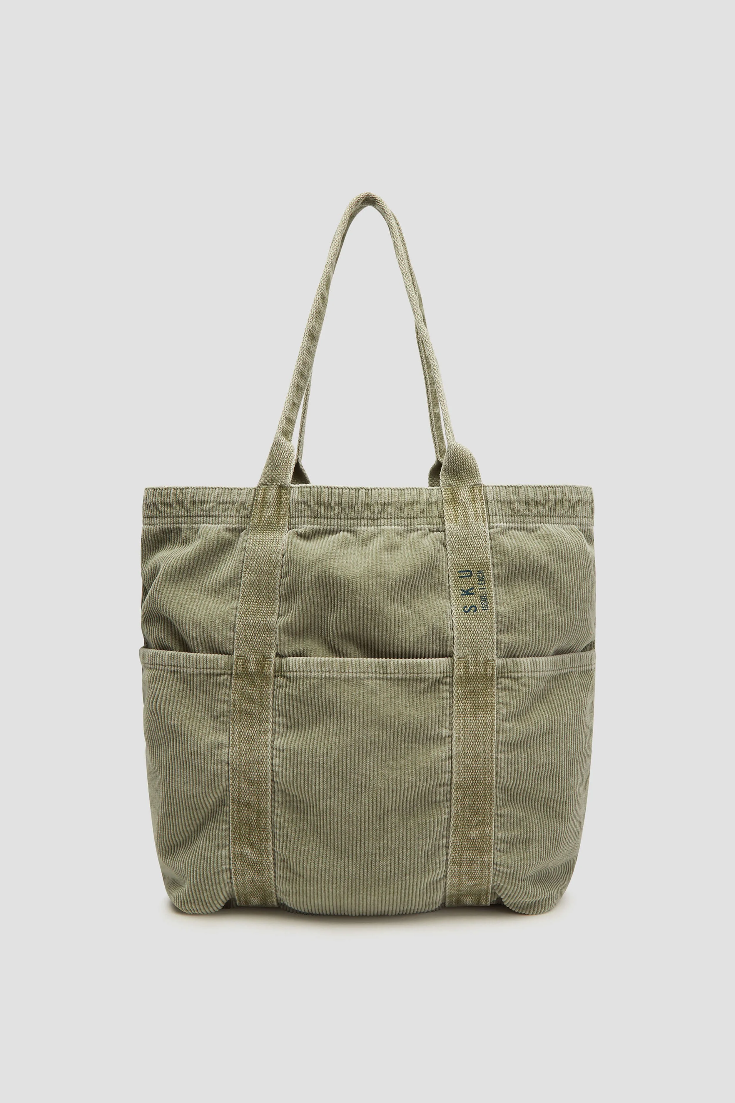 Accessories photography of olive woven tote bag for sustainable fashion brand
