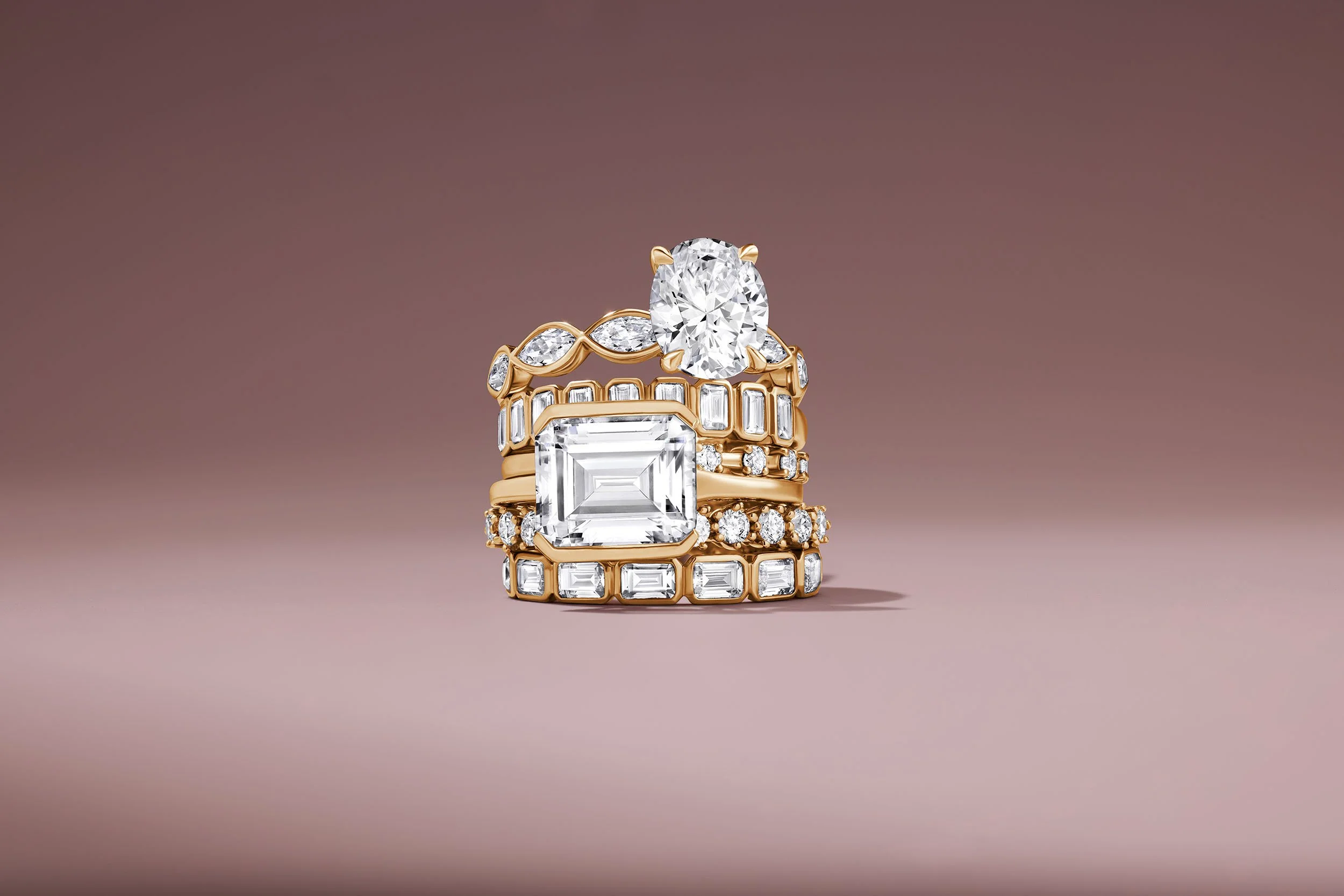 Stack of gold and diamond engagment rings for online retailer Mejuri.