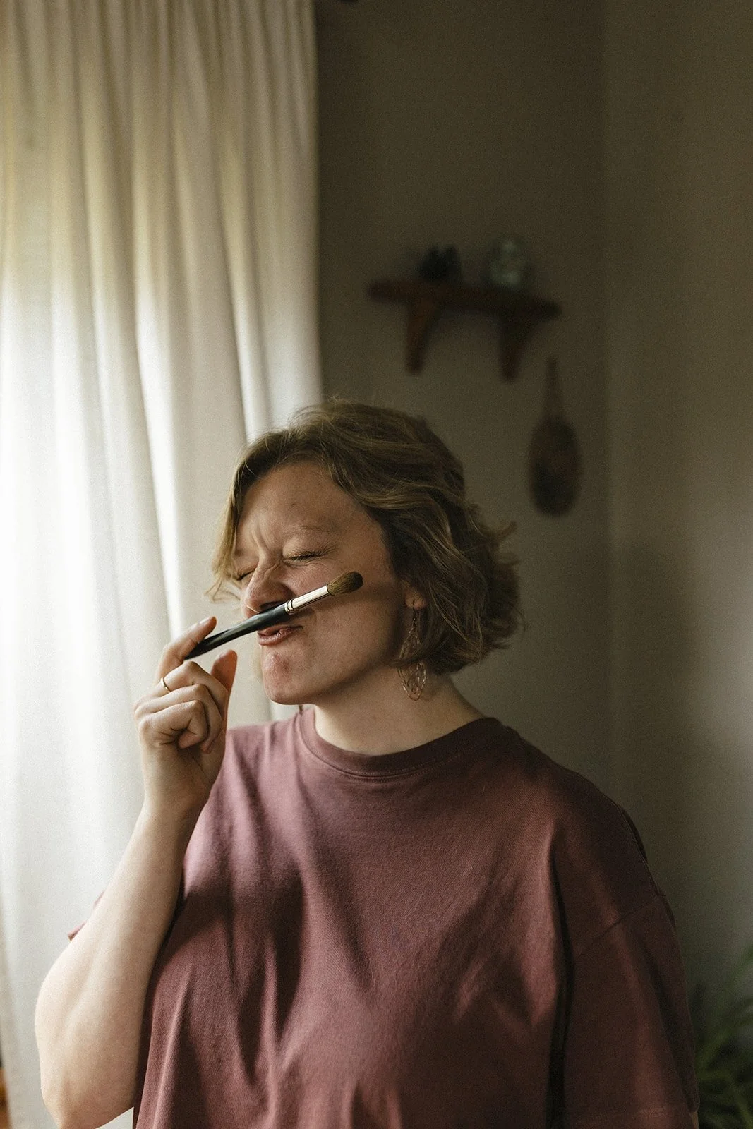 Portrait of Jes holding a paintbrush