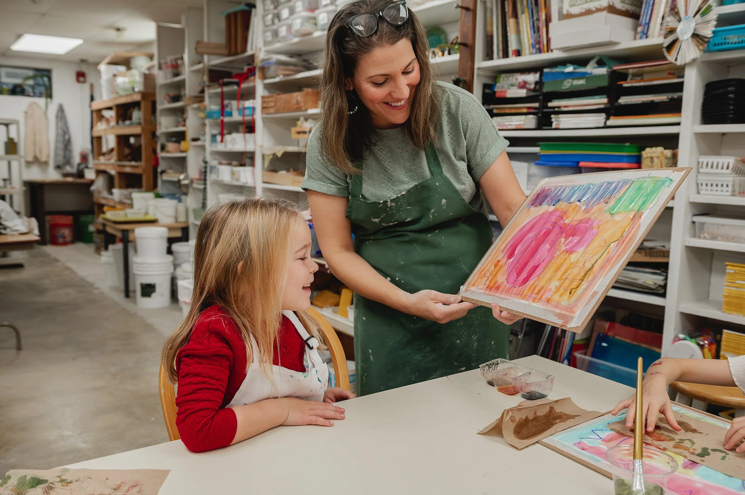 Art instructor and student admiring water color art work