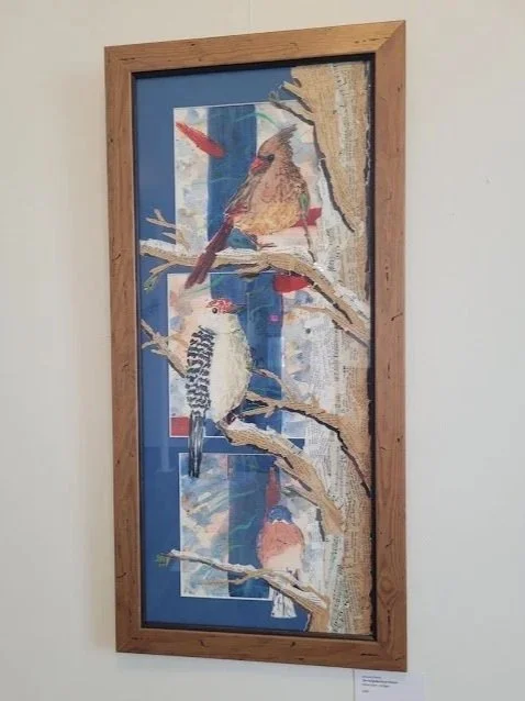 Neighborhood Watch, a painting featuring a cardinal, a red-bellied woodpecker, and a bluebird in a tree