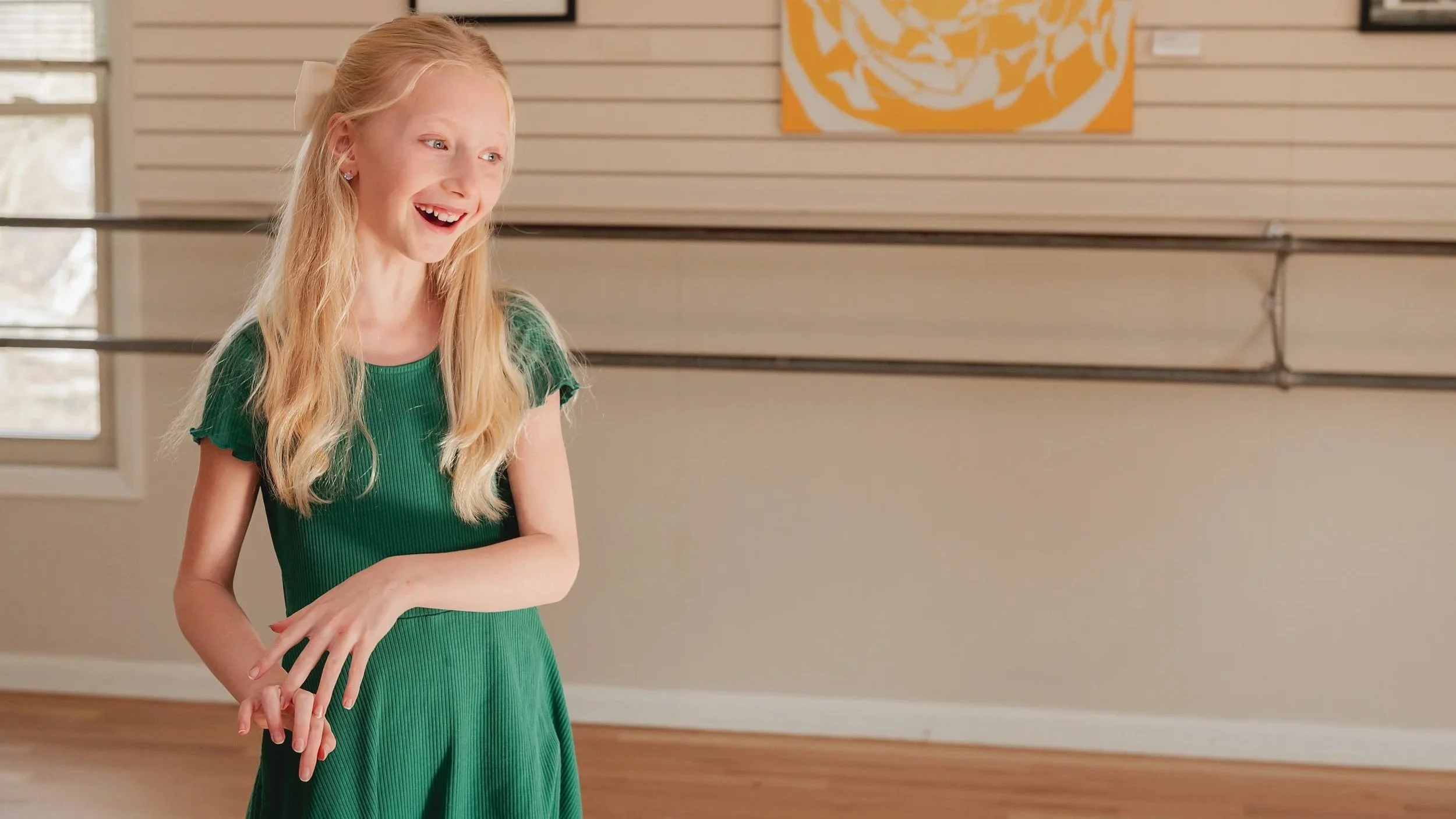 Girl wearing a green dress smiling