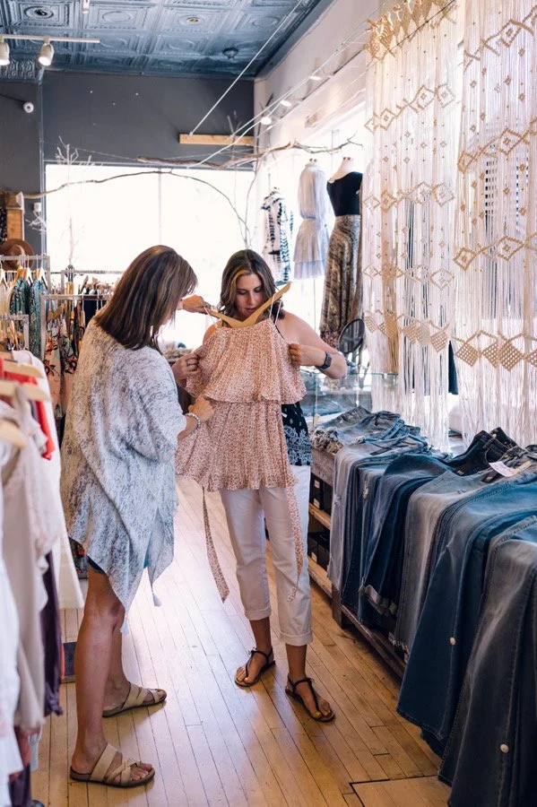 personal shopper with client showing dress .JPG