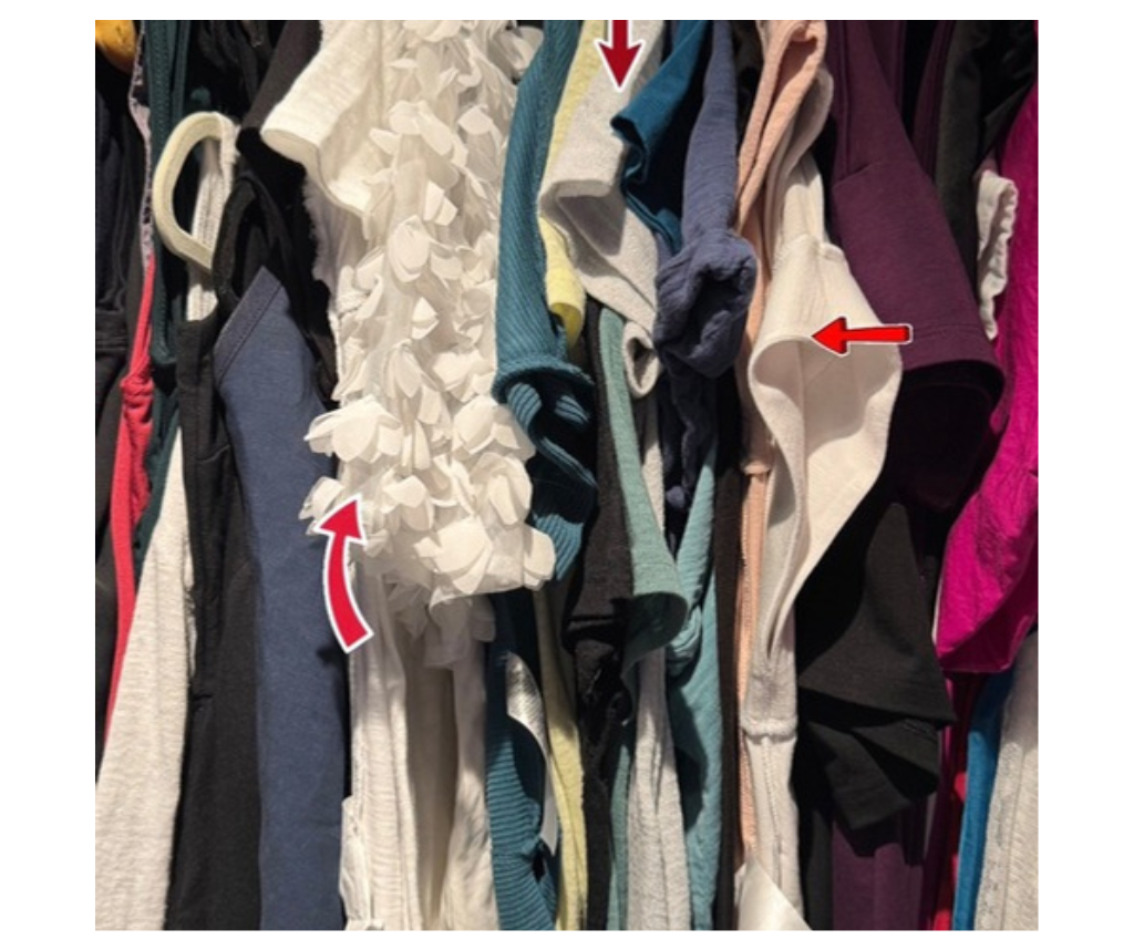 tee shirts hanging in a closet