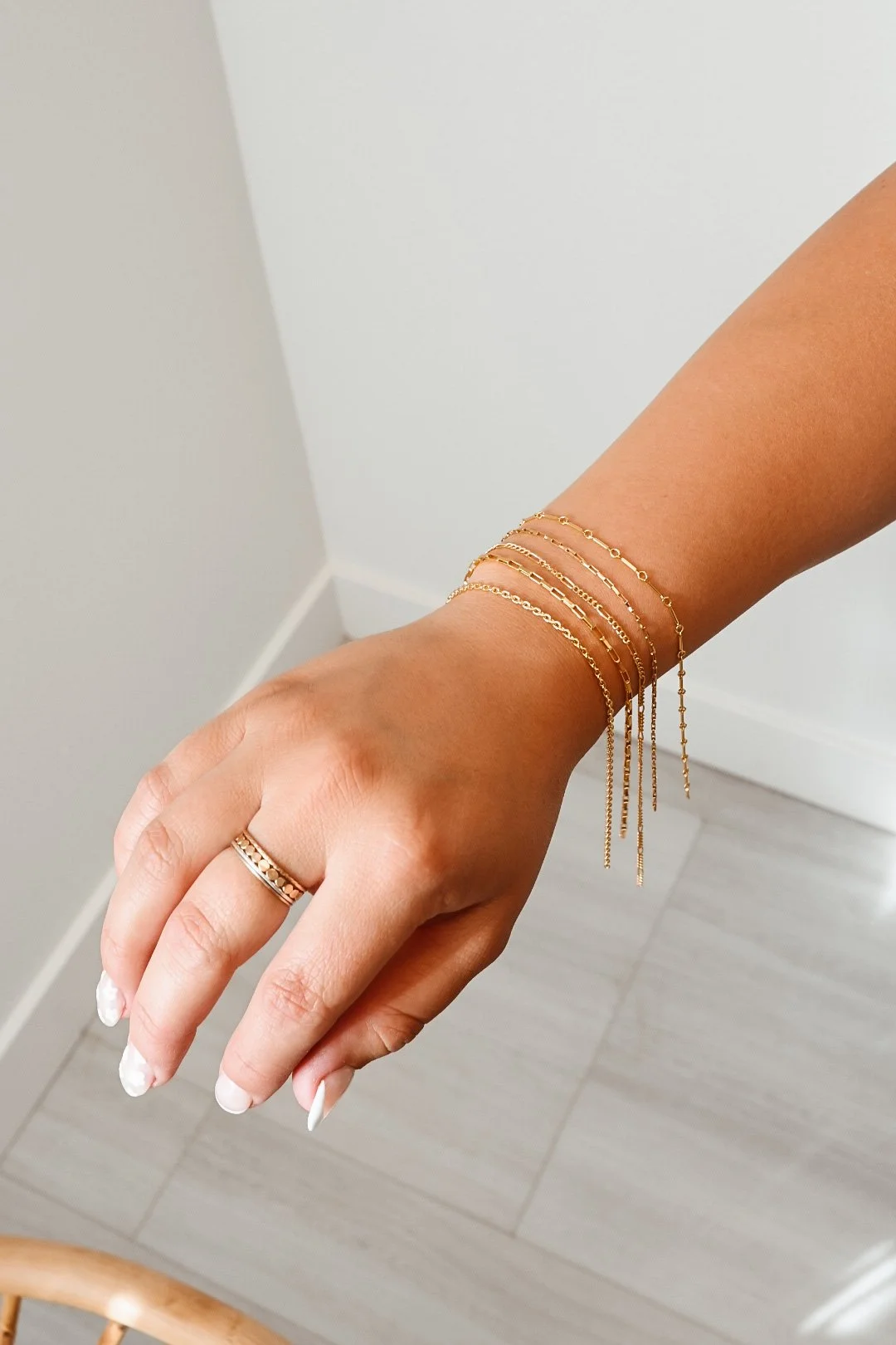 Delicate gold permanent jewelry bracelets by MIKU Jewelry in Frederick, MD