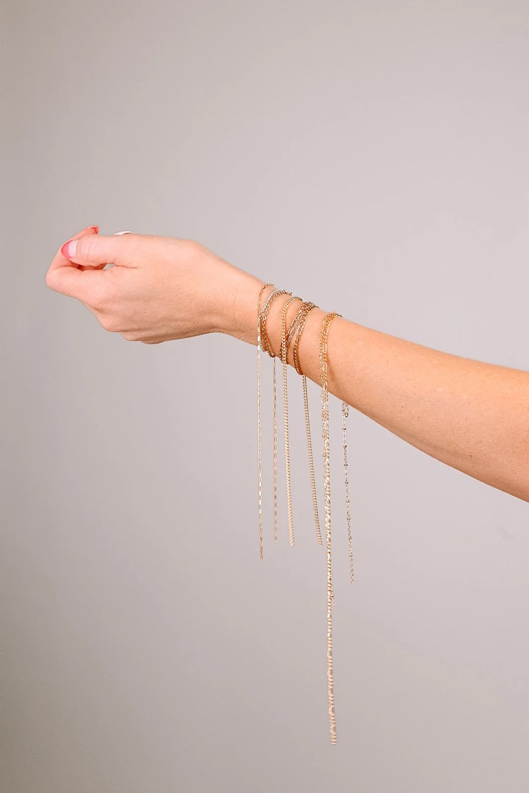 Layered gold permanent jewelry bracelets for events by MIKU Jewelry in Frederick, MD