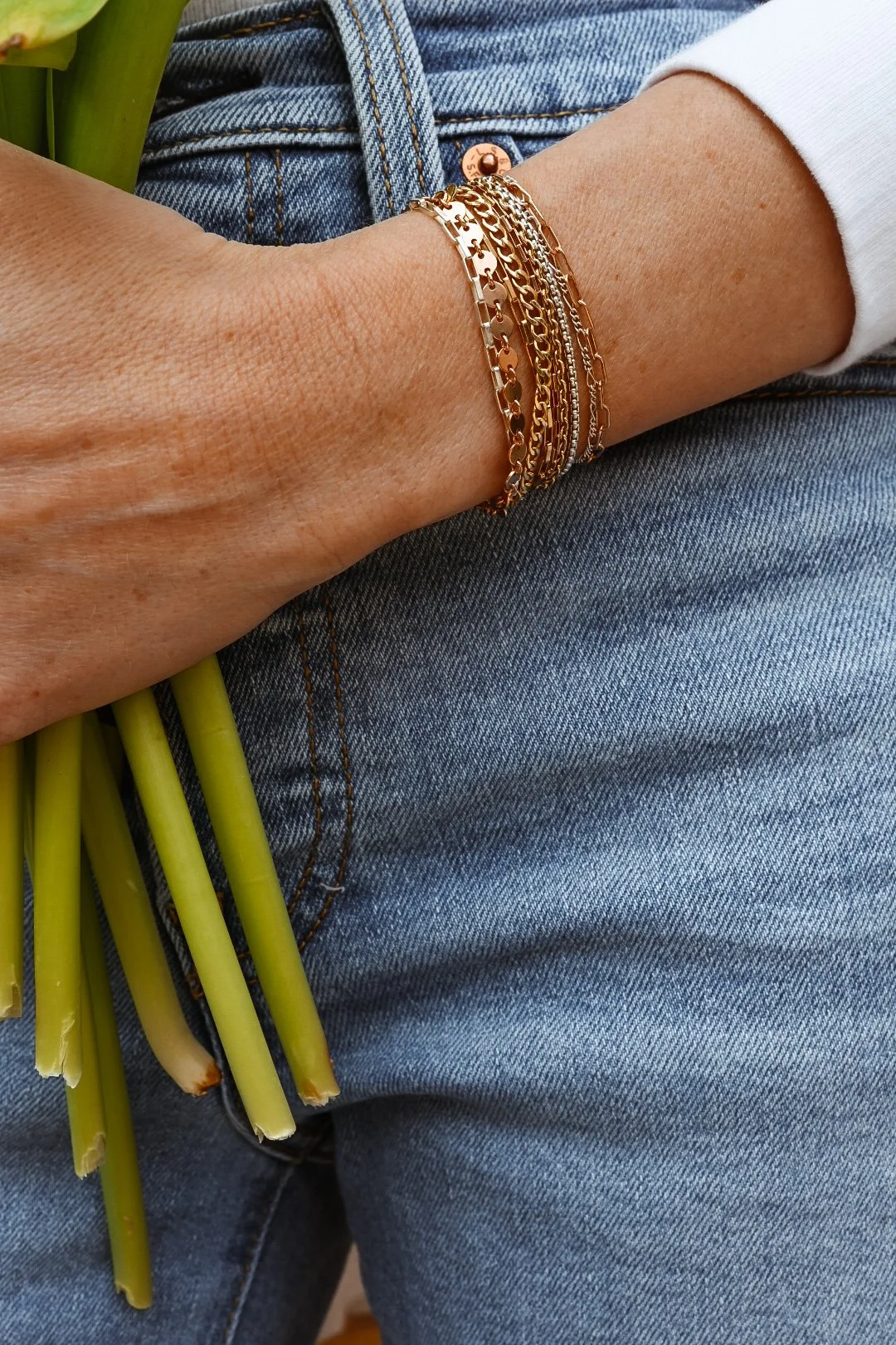 Layered gold permanent jewelry bracelets by MIKU Jewelry in Frederick, MD