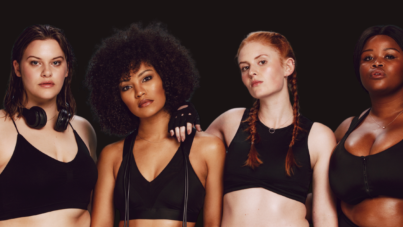 Four women in athletic wear posing confidently against a dark background.