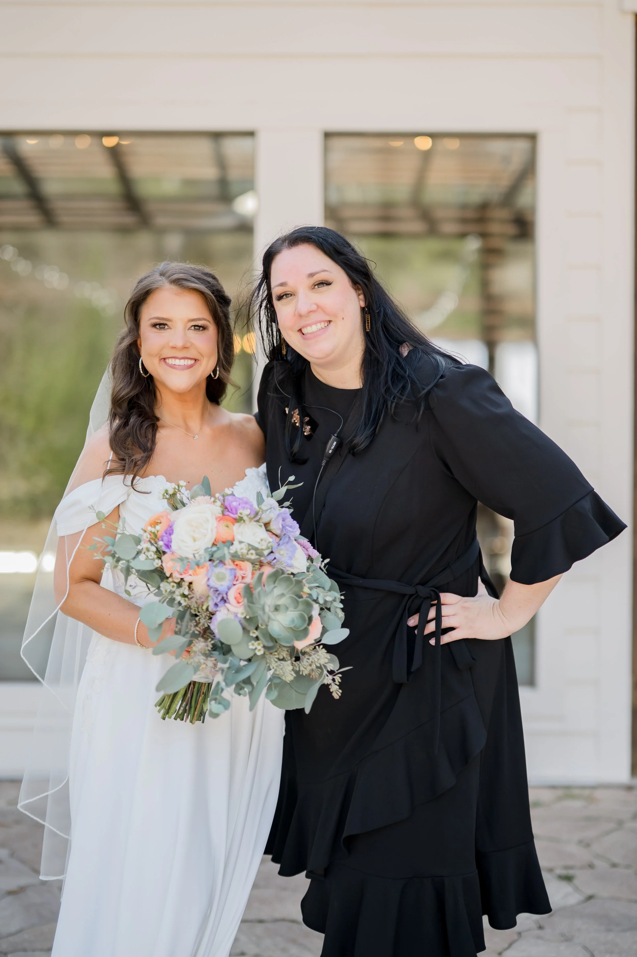 Wedding planner with bride holding a succulent and floral boquet.