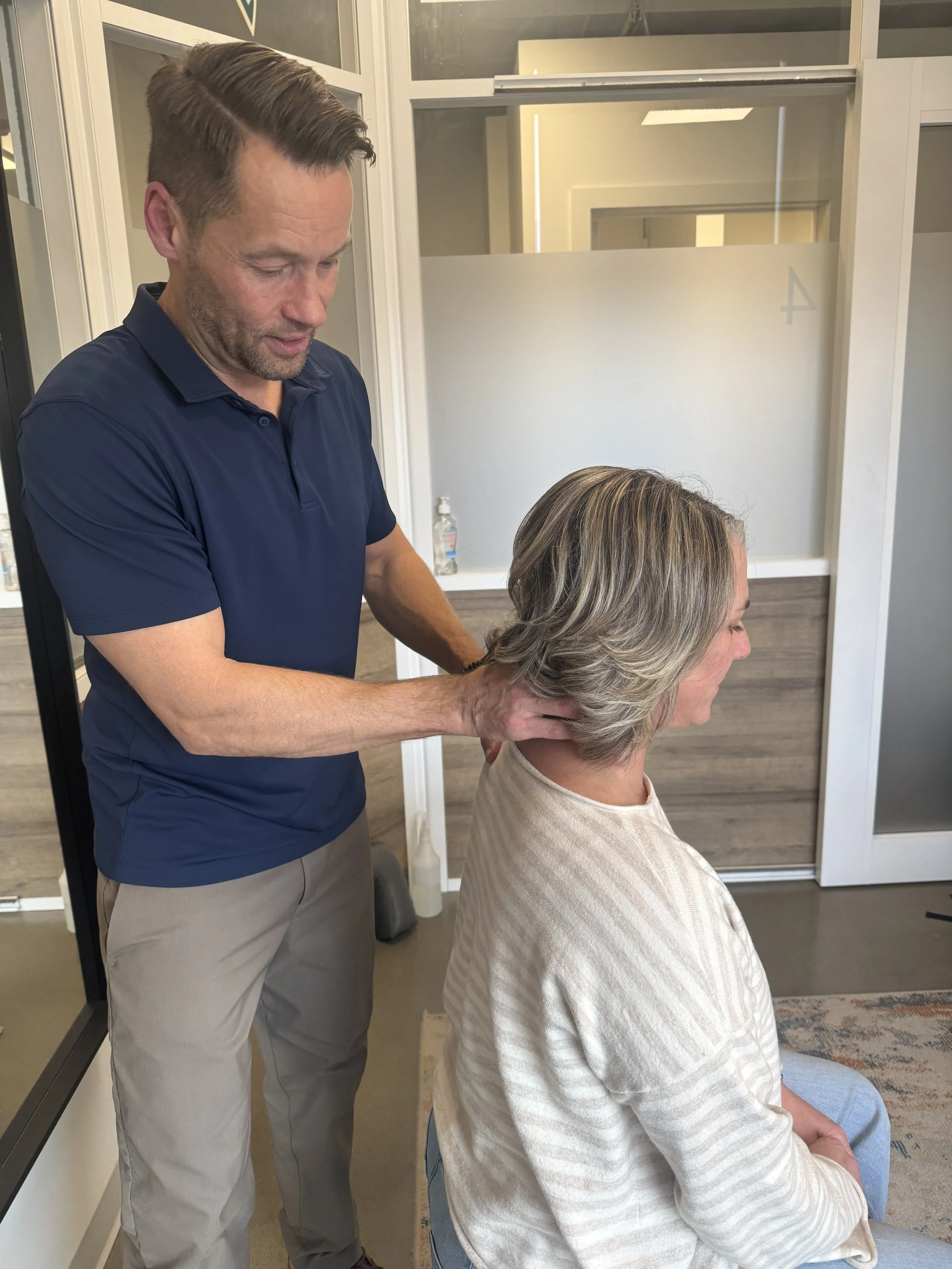 Dr. Gordon performing an upper cervical chiropractic assessment in his Calgary clinic